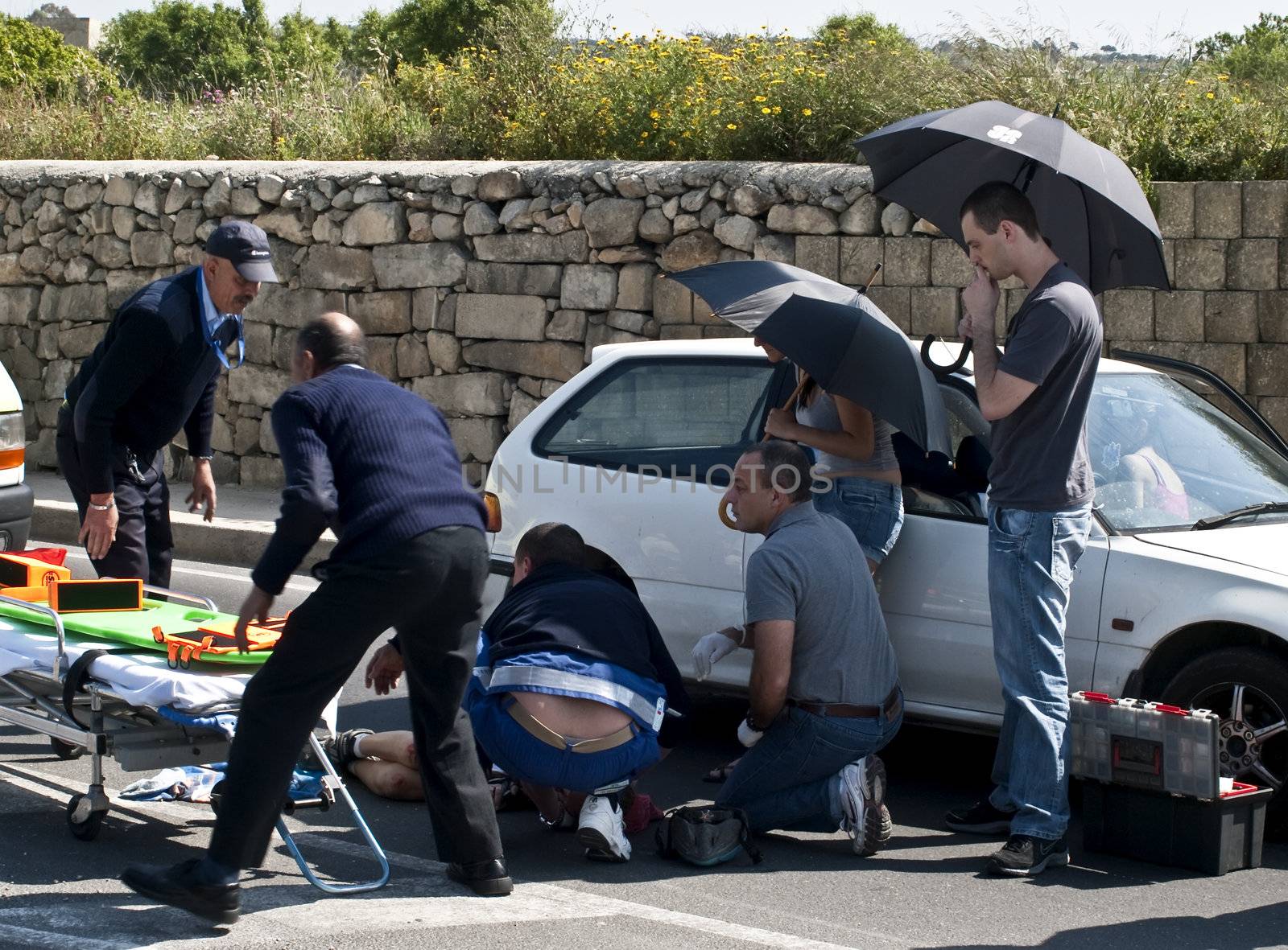 MOSTA, MALTA - APR16 - An injured cyclist receives first aid from ambulance crew on April 16, 2009