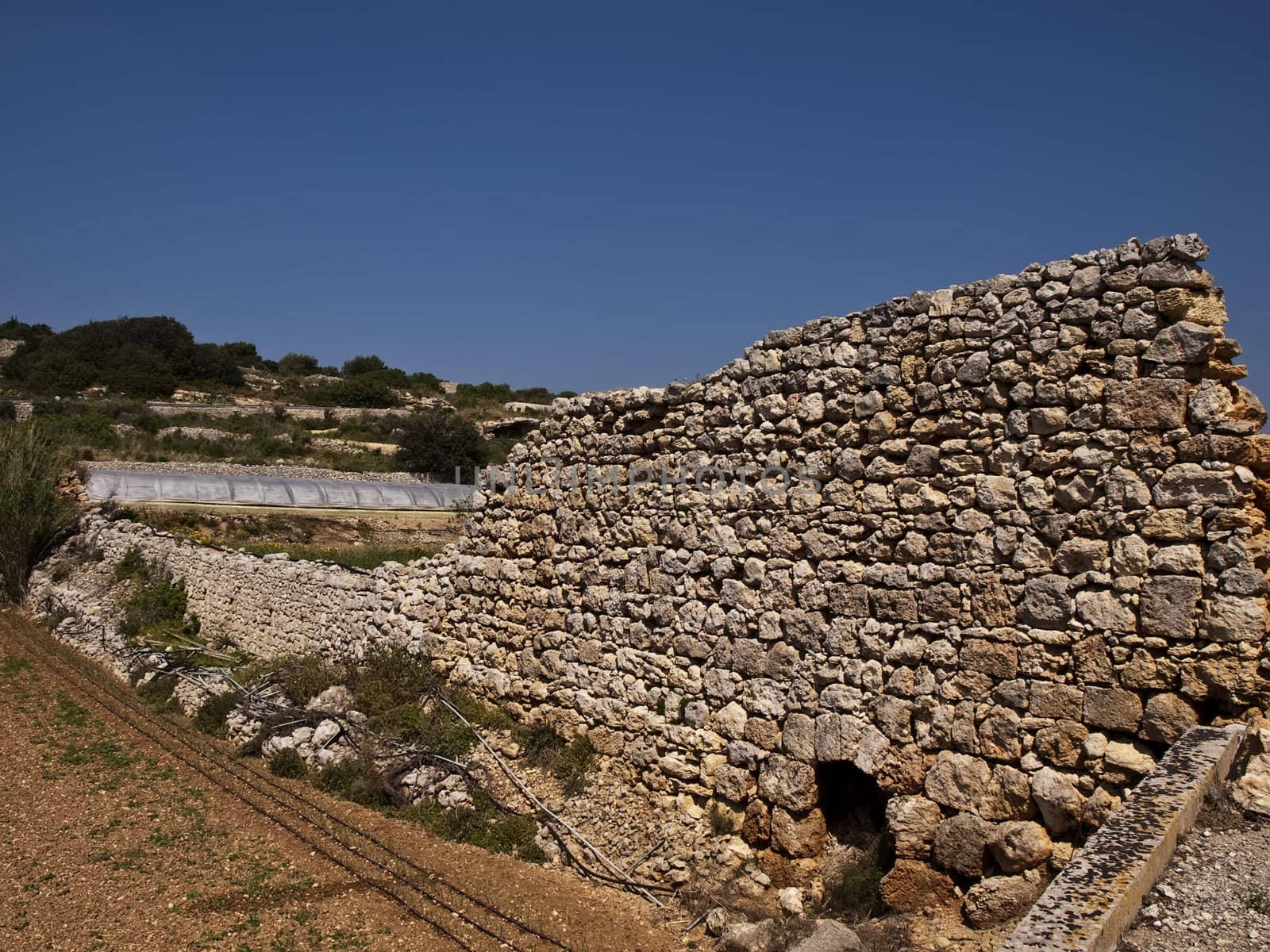 An old and neglected historic Roman wall on the island of Malta