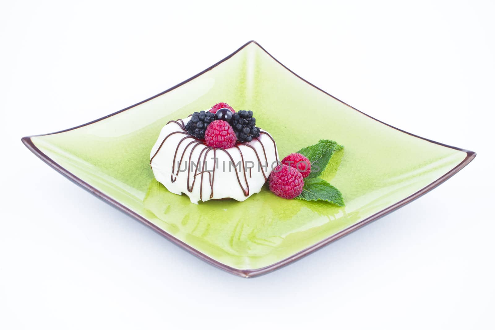 Black and White chocolate with blackberries on green plate