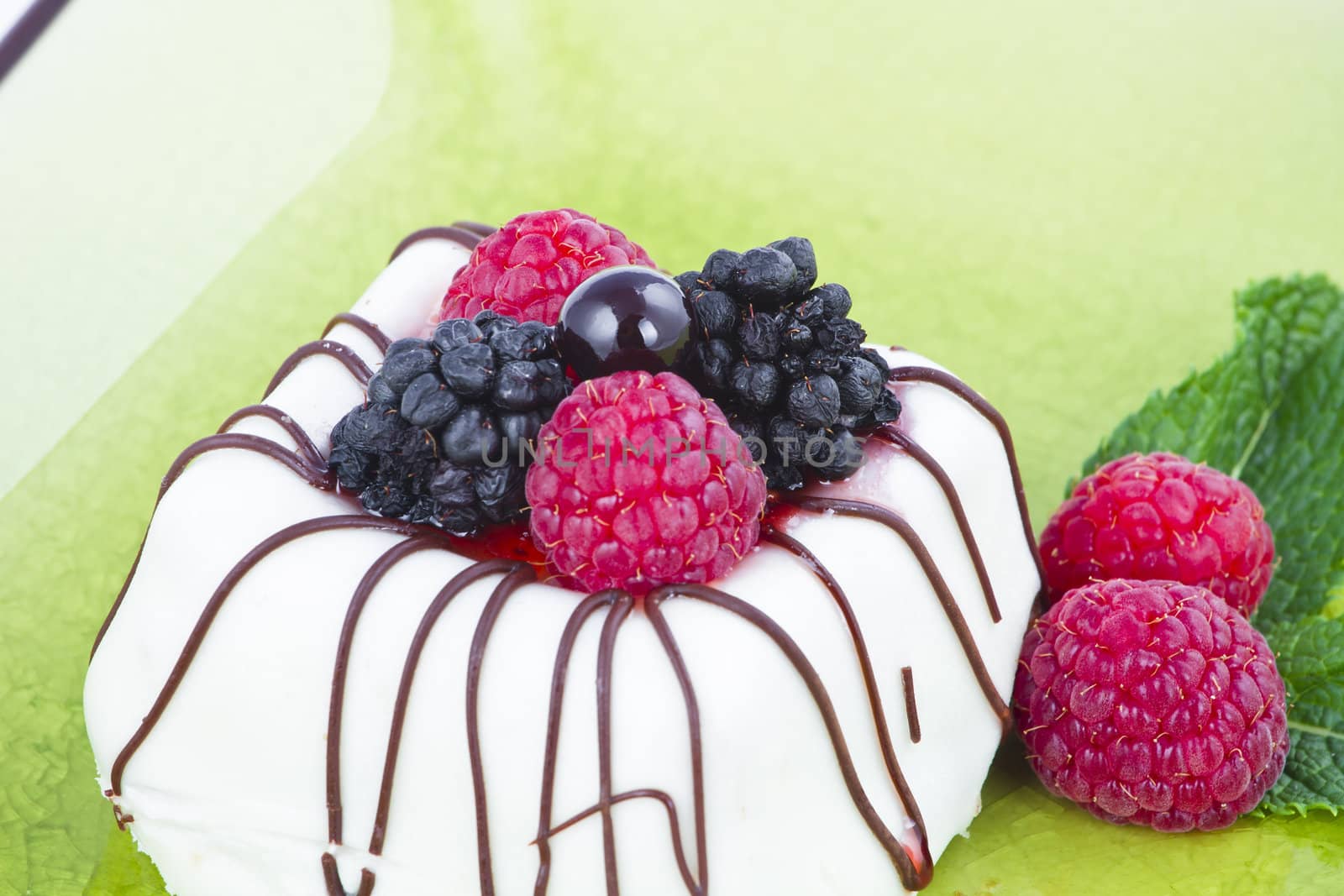 Black and White chocolate with blackberries on green plate