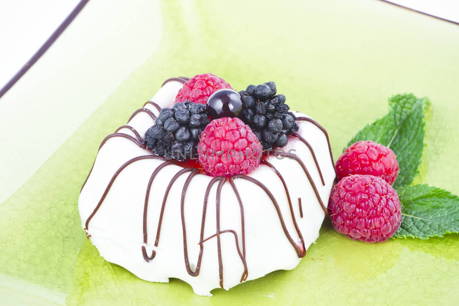 Black and White chocolate with blackberries on green plate