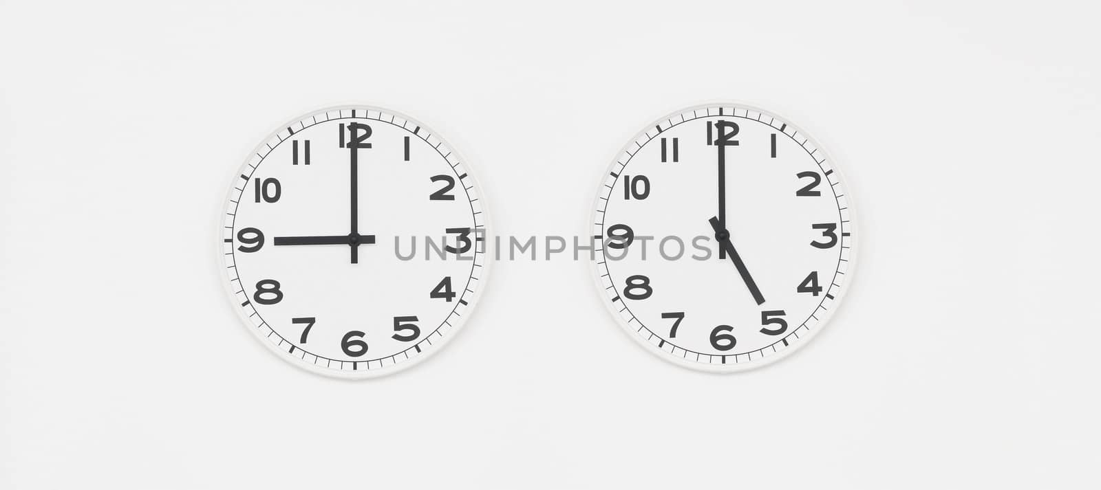 White clock with black hands showing nine to five o'clock by AlessandroZocc