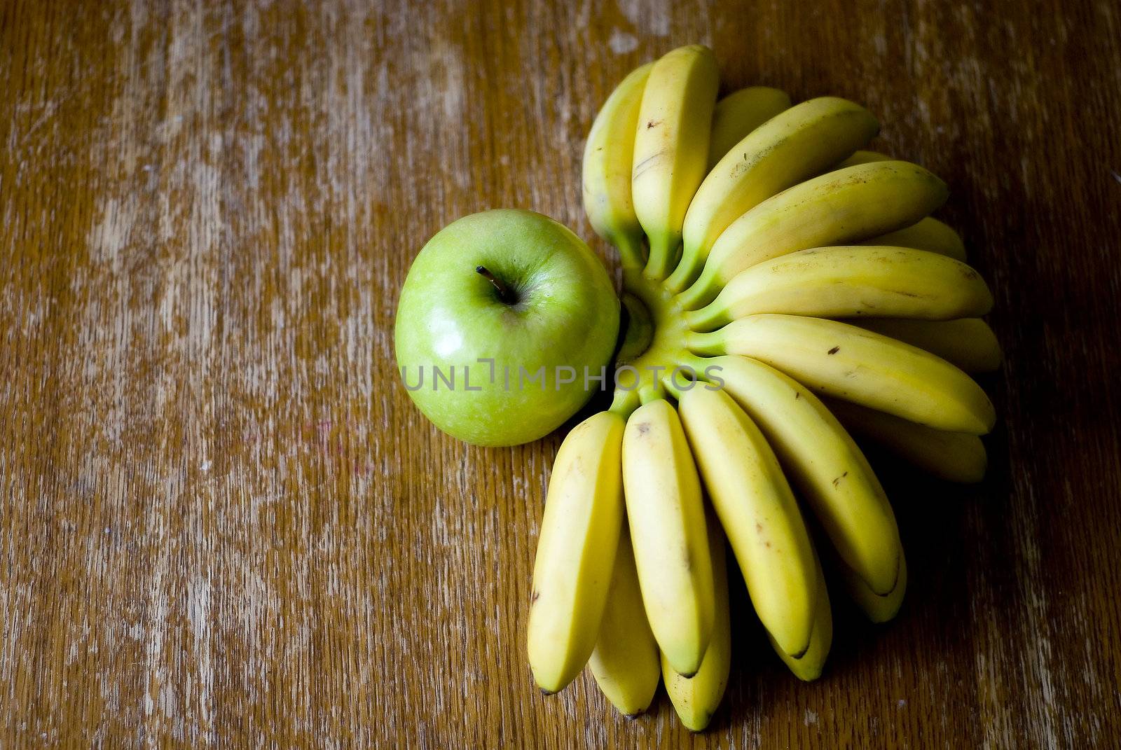 Still life with mini bananas and apple