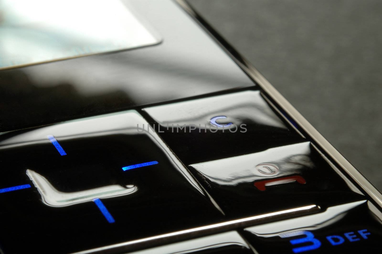 Close up shot of blue mobile keypad under dark environment