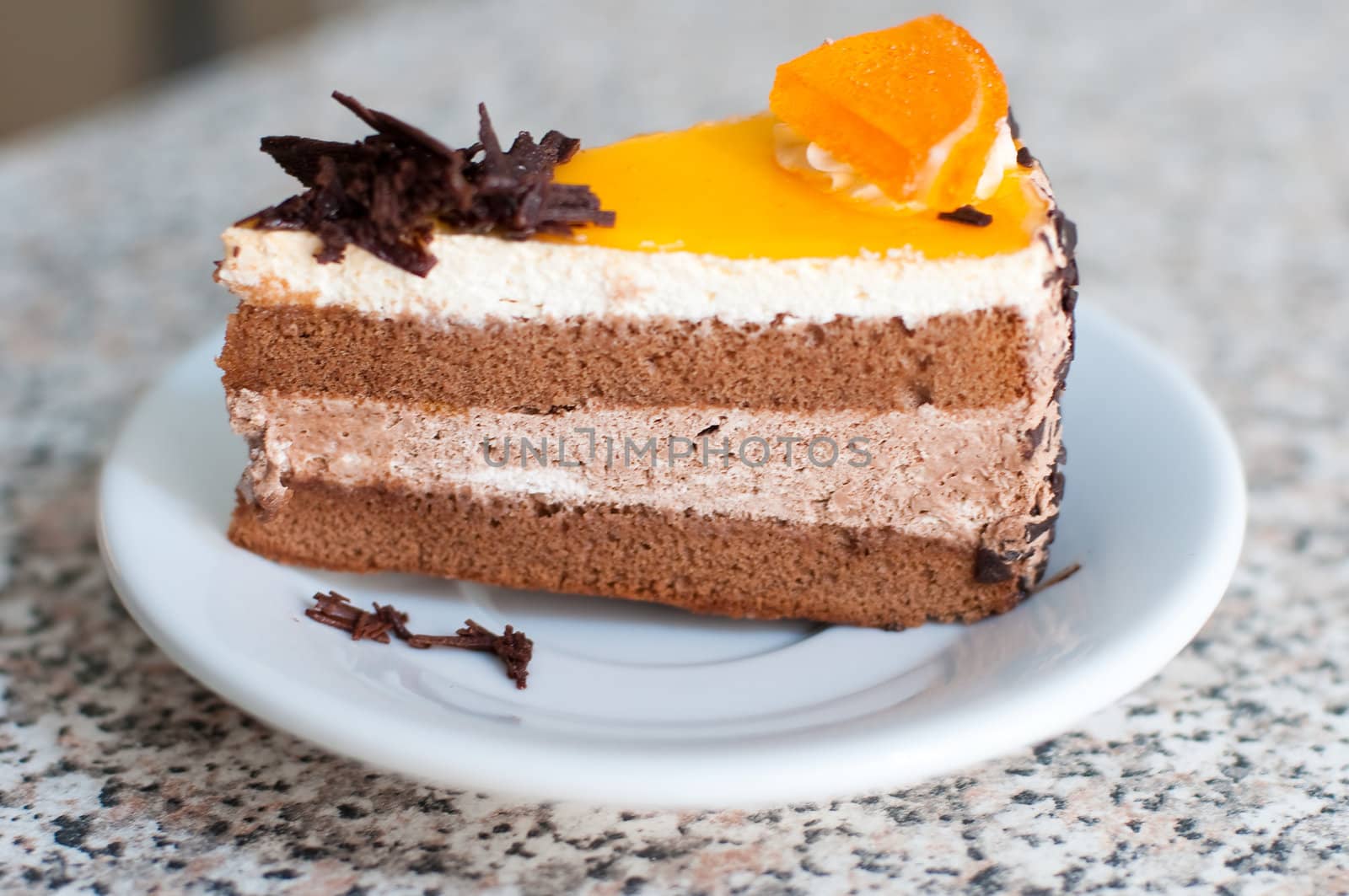 chocolate cake with piece of orange on top