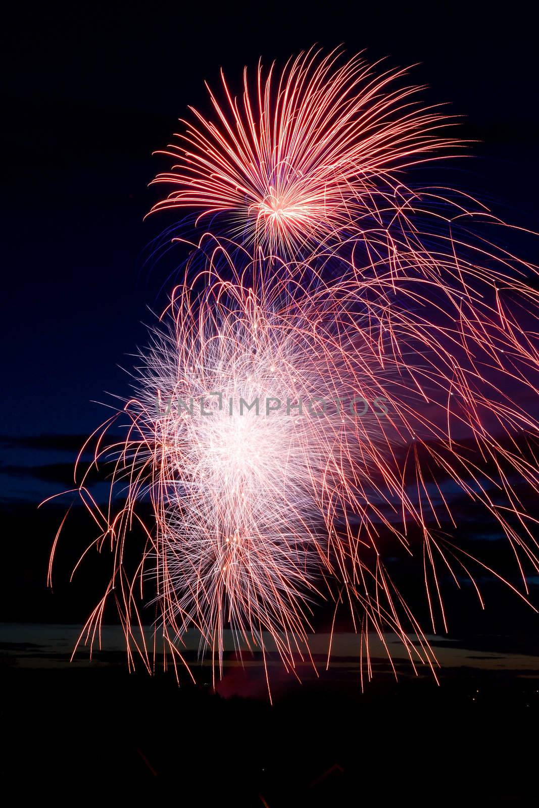 Bright and coloufull fireworks with cloudy night time sky