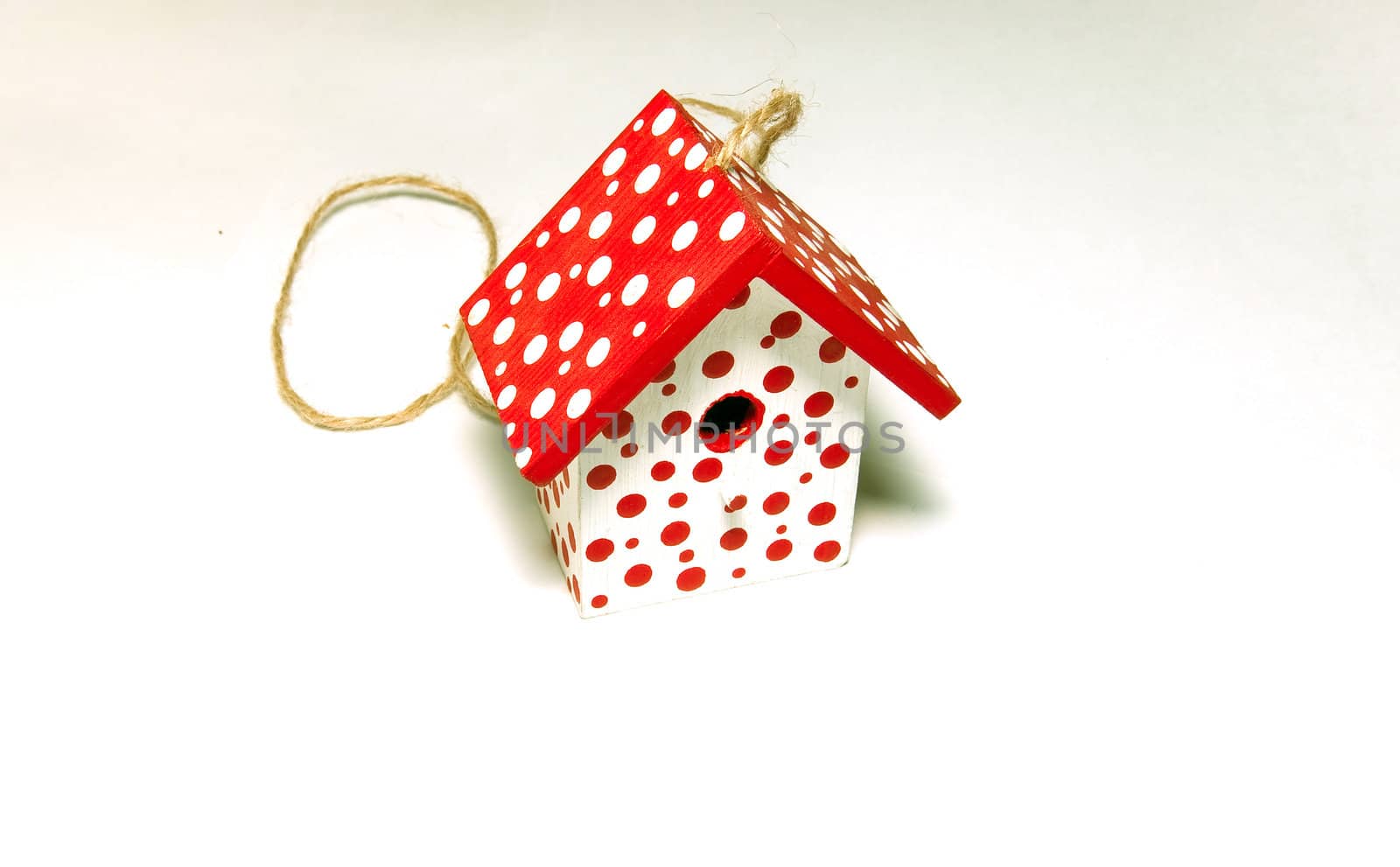 Red and white toy birdhouse