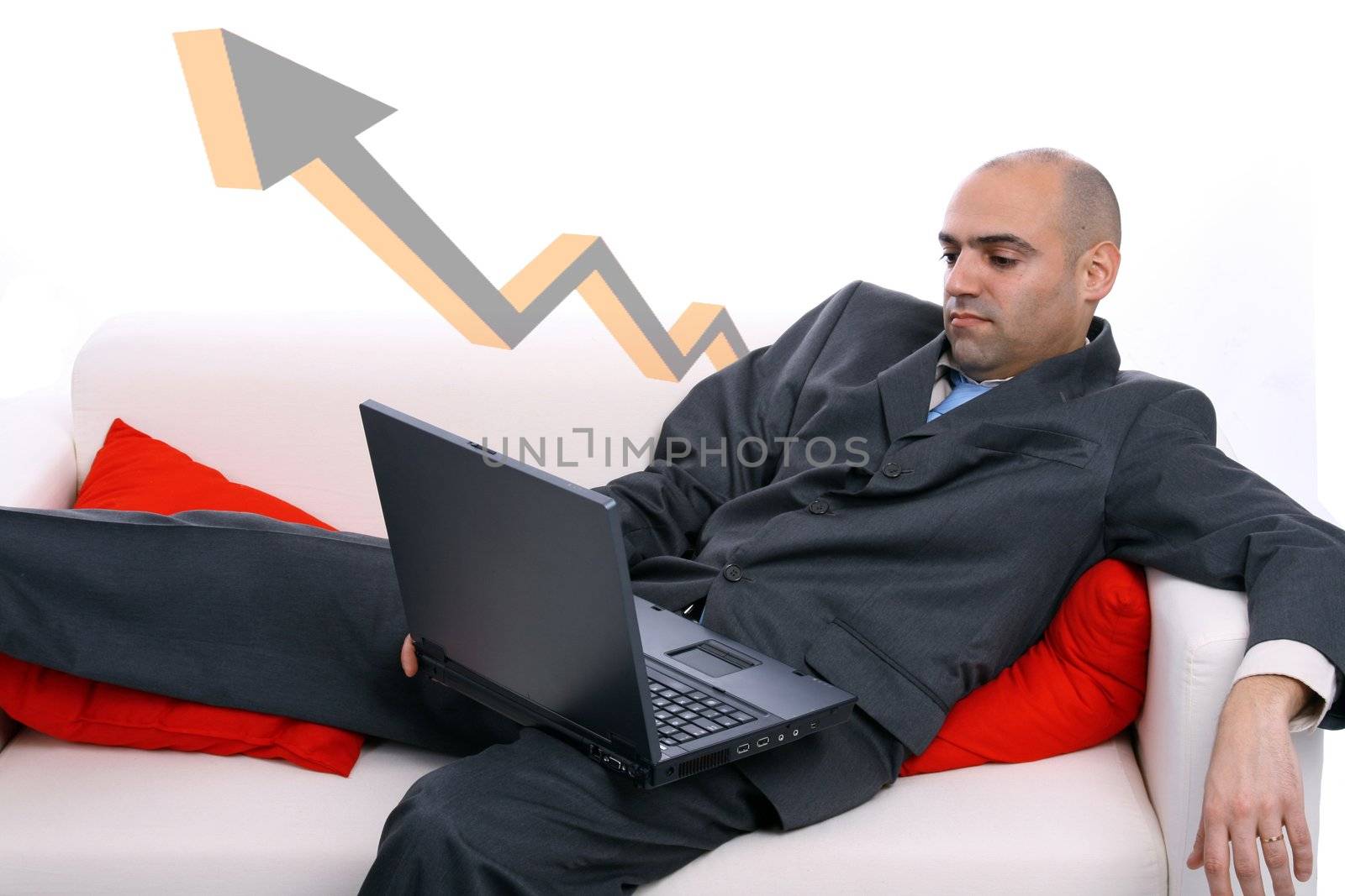 businessman working on the sofa with red pillows