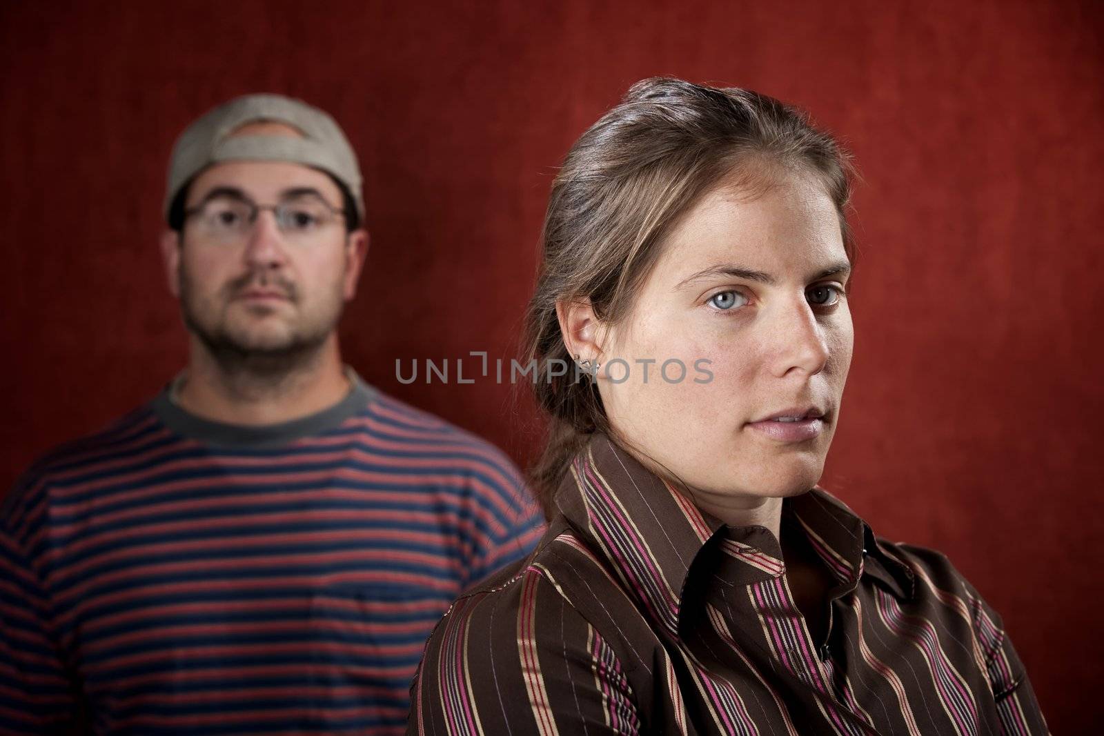 Guilty woman with upset man in the background