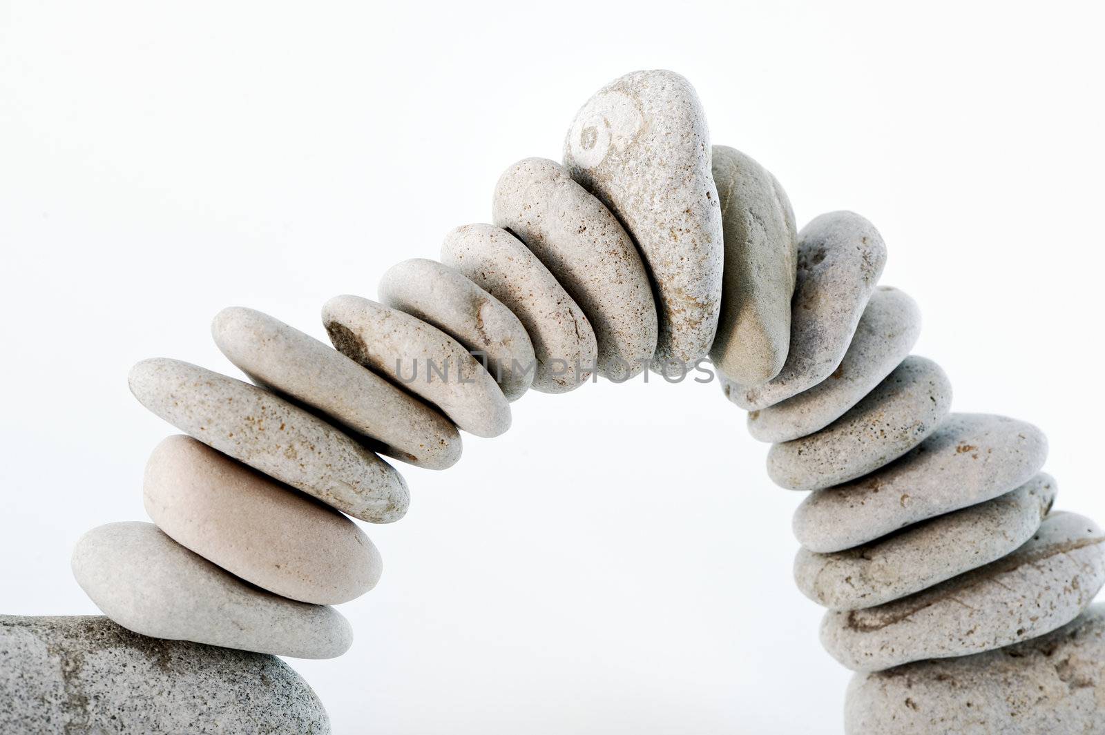 large and small white stones form an arc