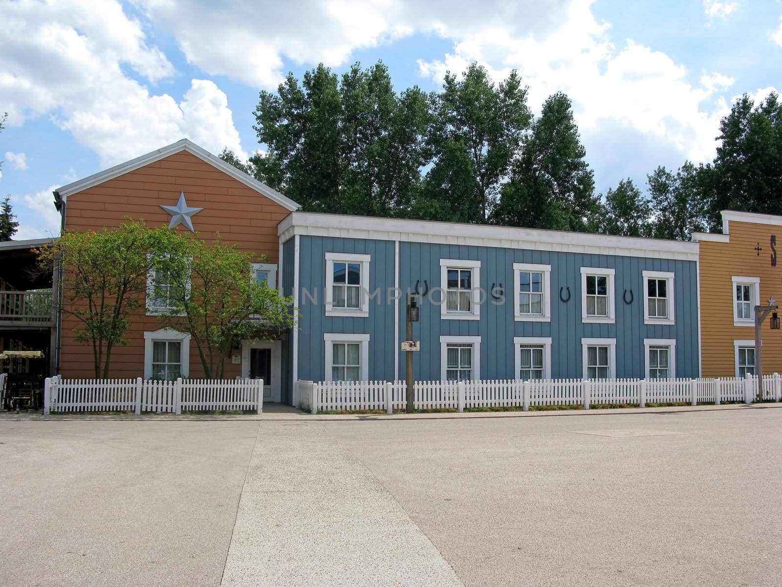 A deserted cowboy town, with wooden buildings.