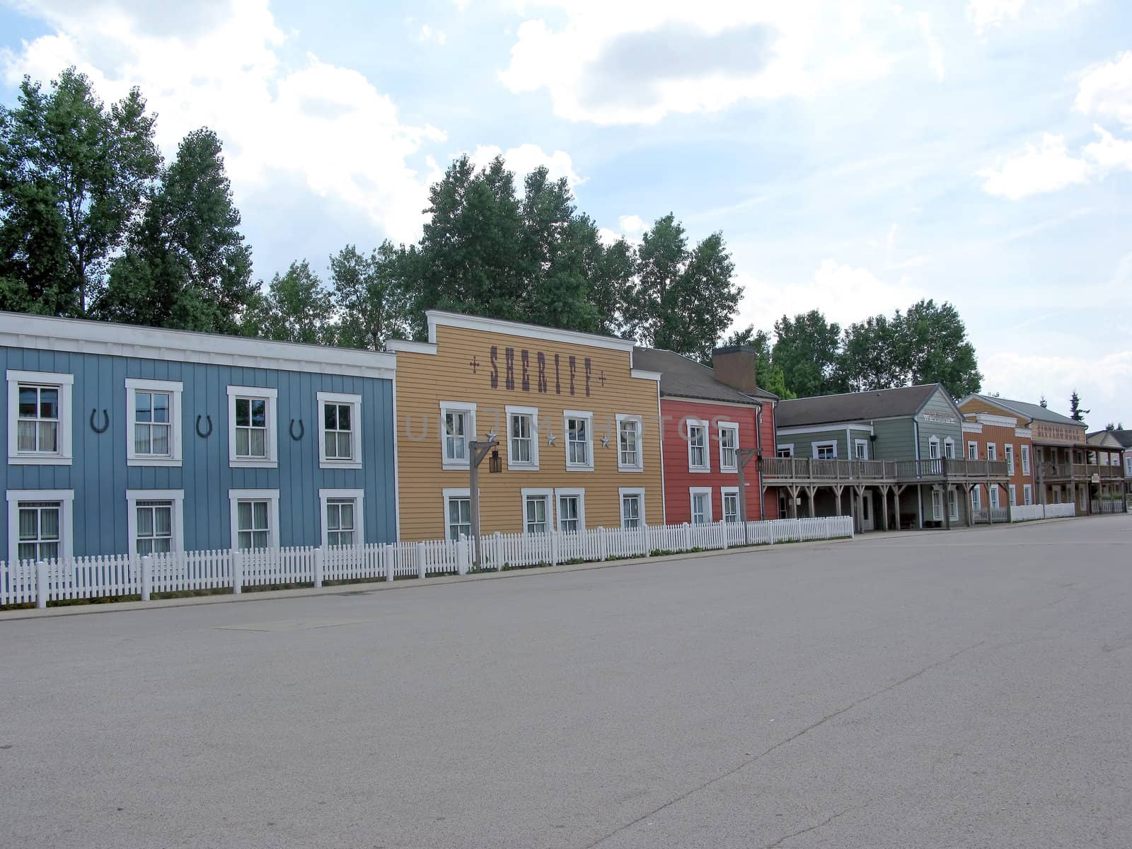 A deserted cowboy town, with wooden buildings.