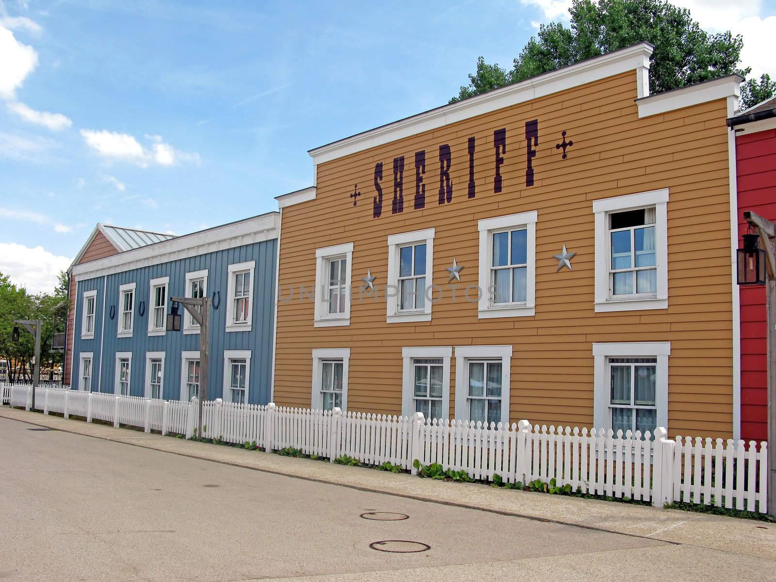 A deserted cowboy town, with wooden buildings.