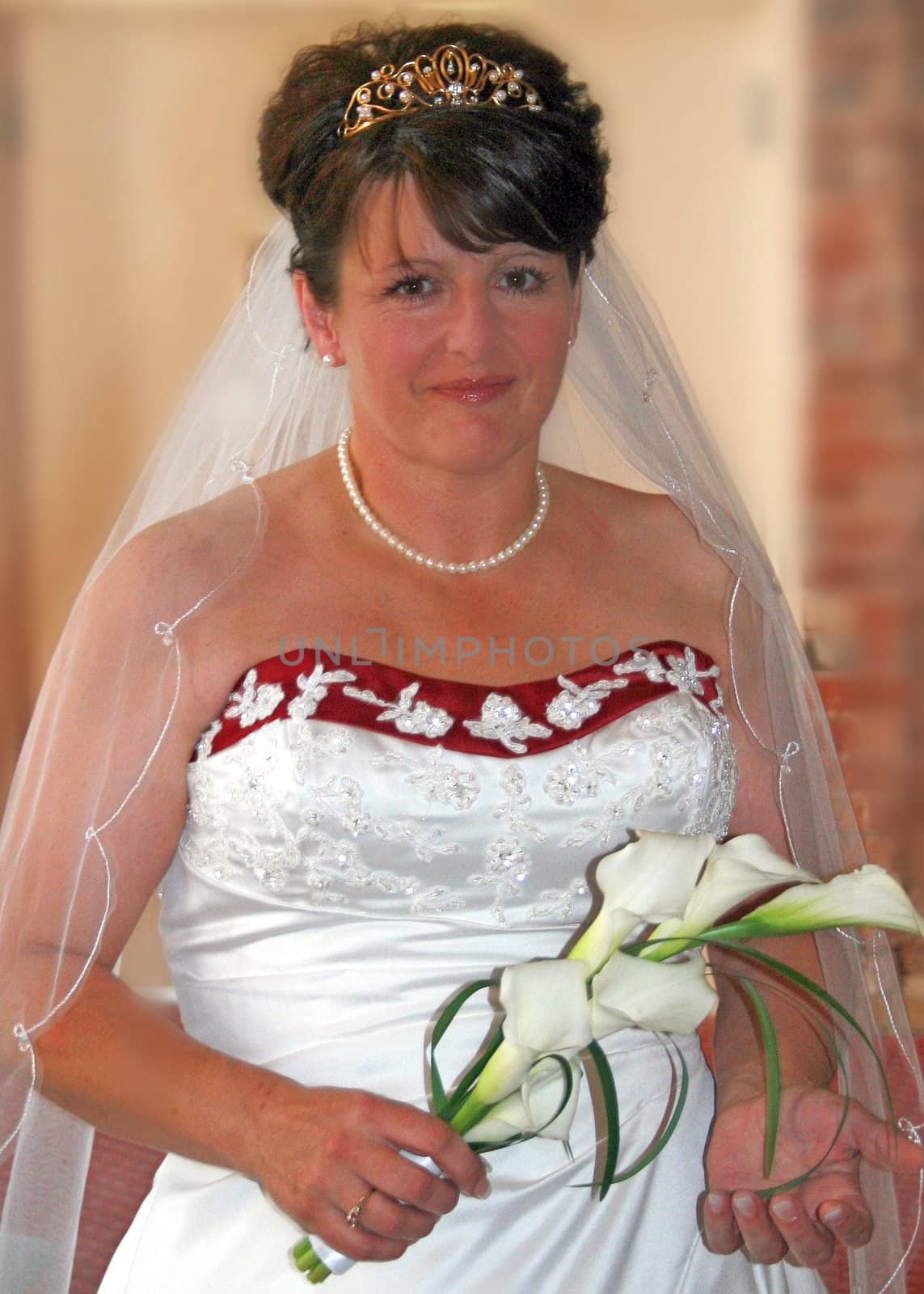 The Bride before the wedding, holding lilies.