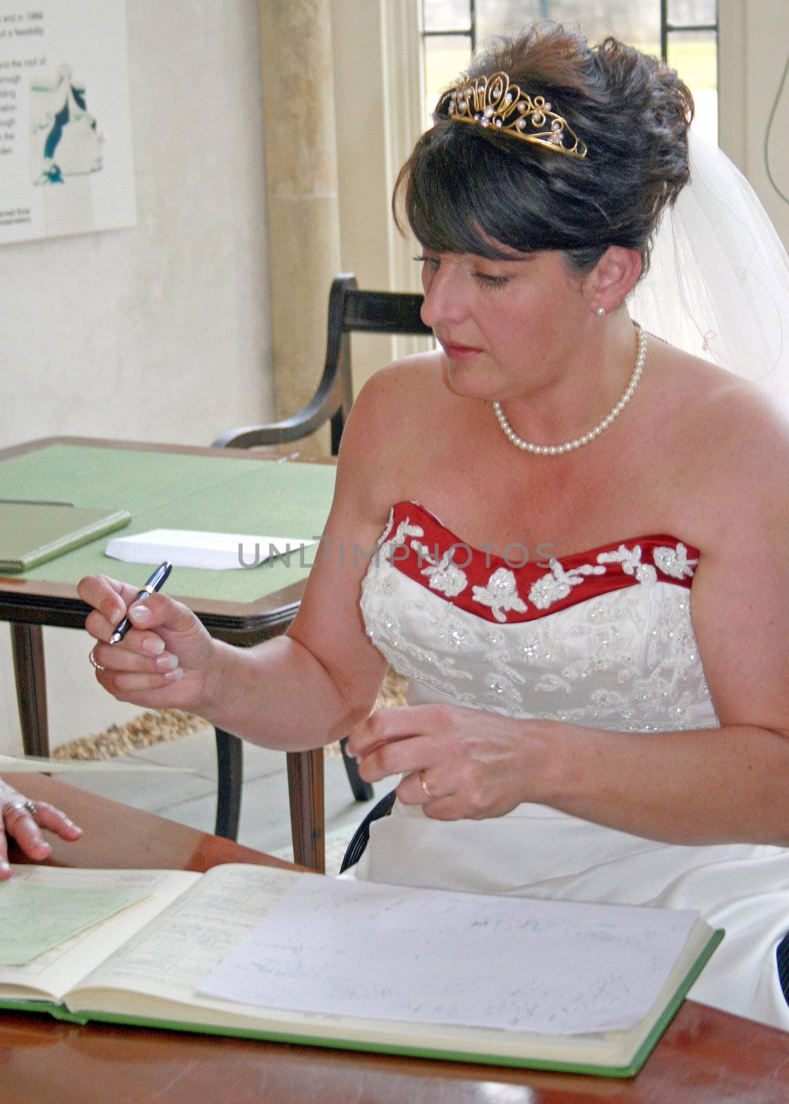 Bride signing the register by quackersnaps