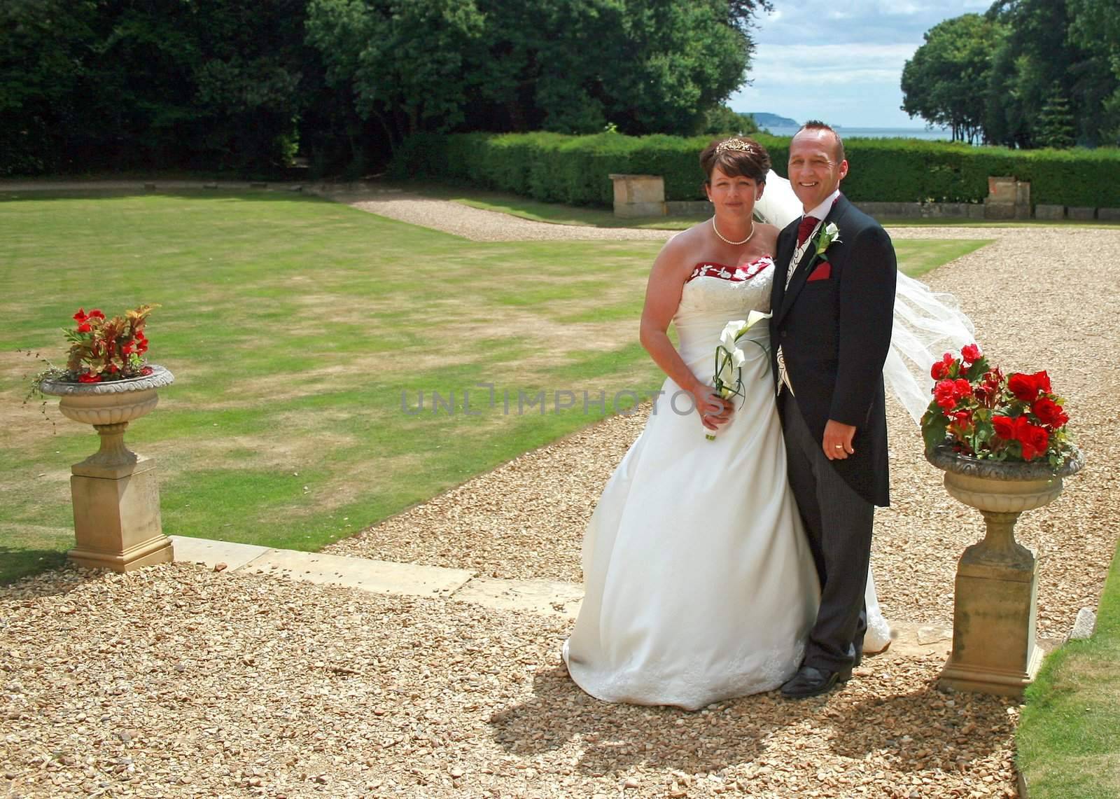 Bride and Groom in the countryside with Roses