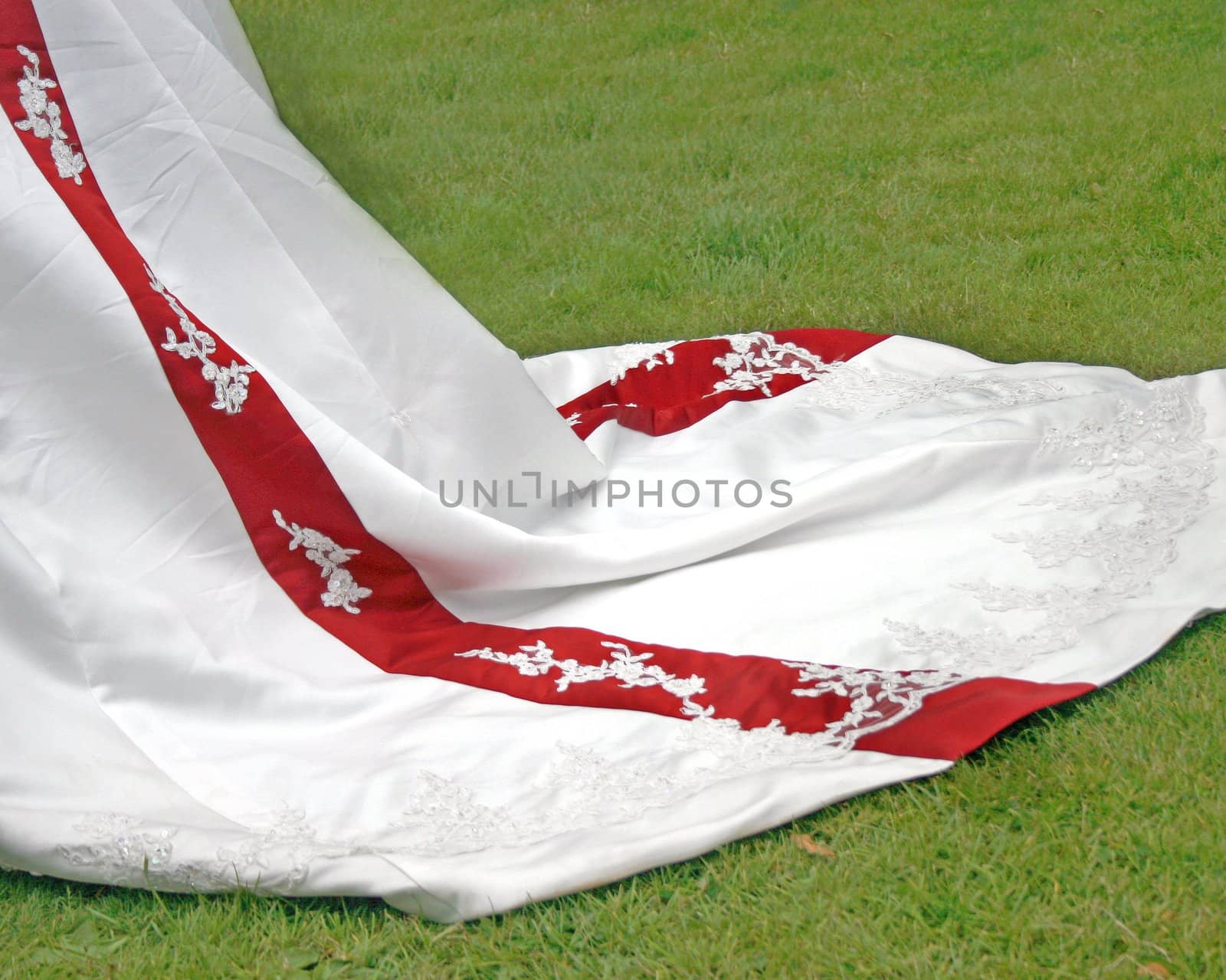 The bottom of a wedding dress with red stripe.