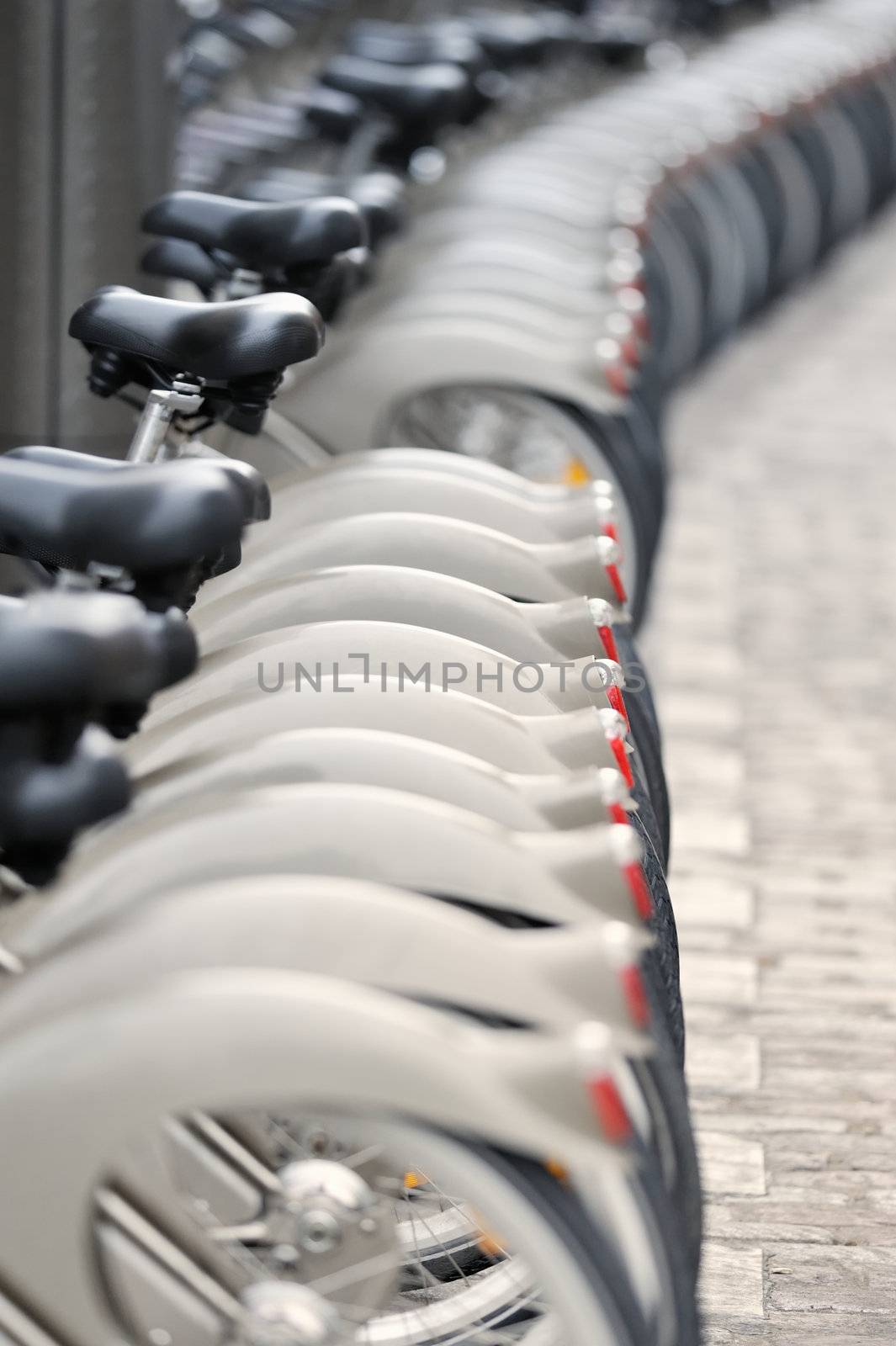 Wheels of bicycles on the walkway. Photo with tilt-shift lens