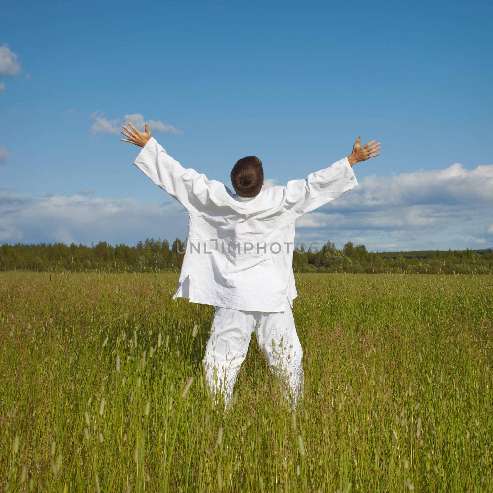 Man enjoys nature and fresh air while standing in a field