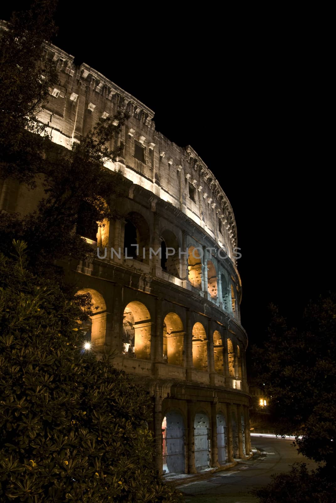 part of the famous coliseum in Rome at night