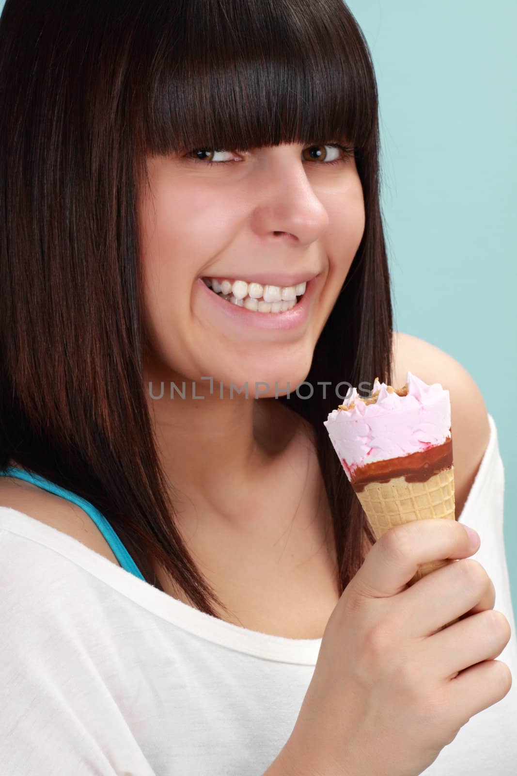 Cute girl holding an ice cream cone, blue background