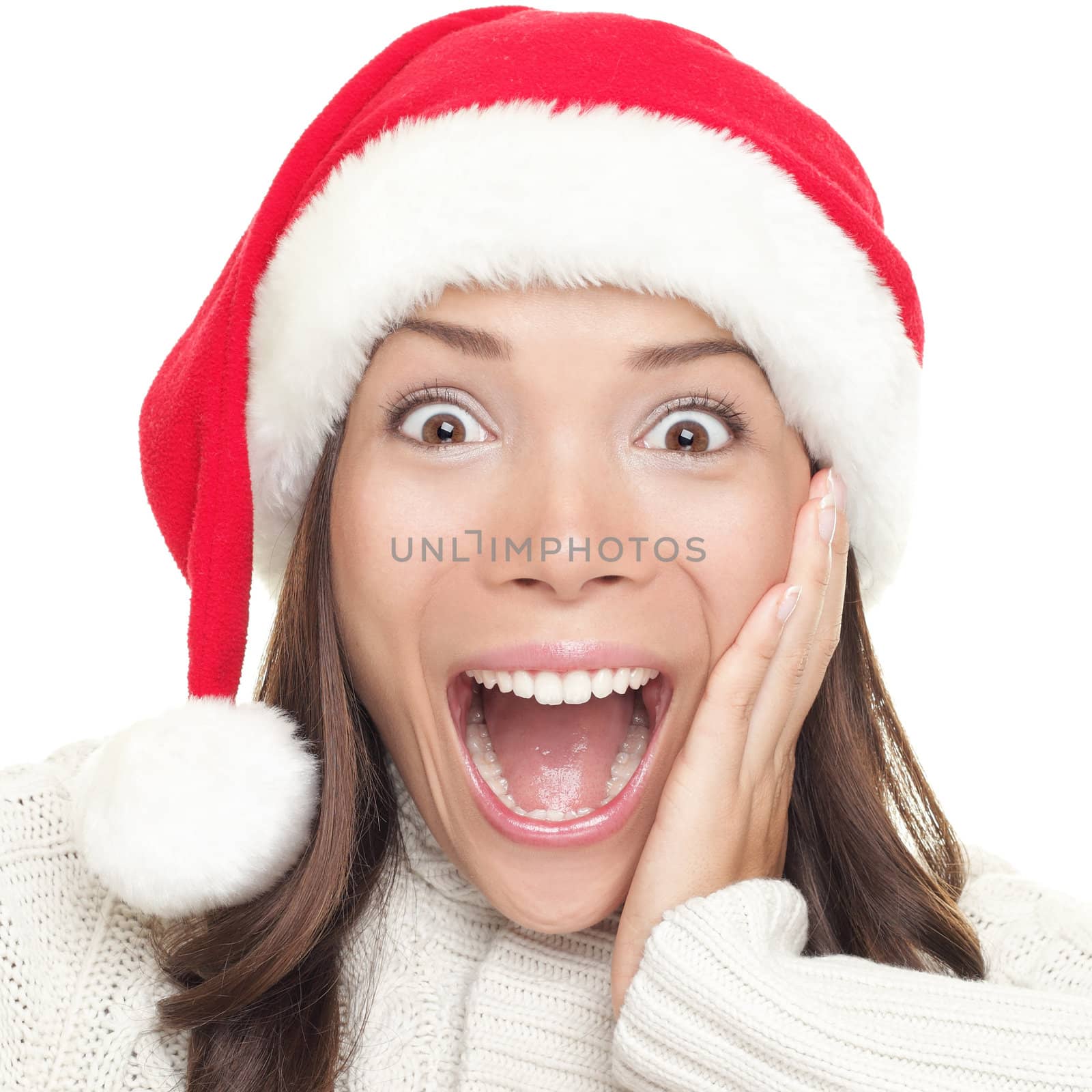 Christmas santa woman surprised. Beautiful face of happy asian woman in santa hat.