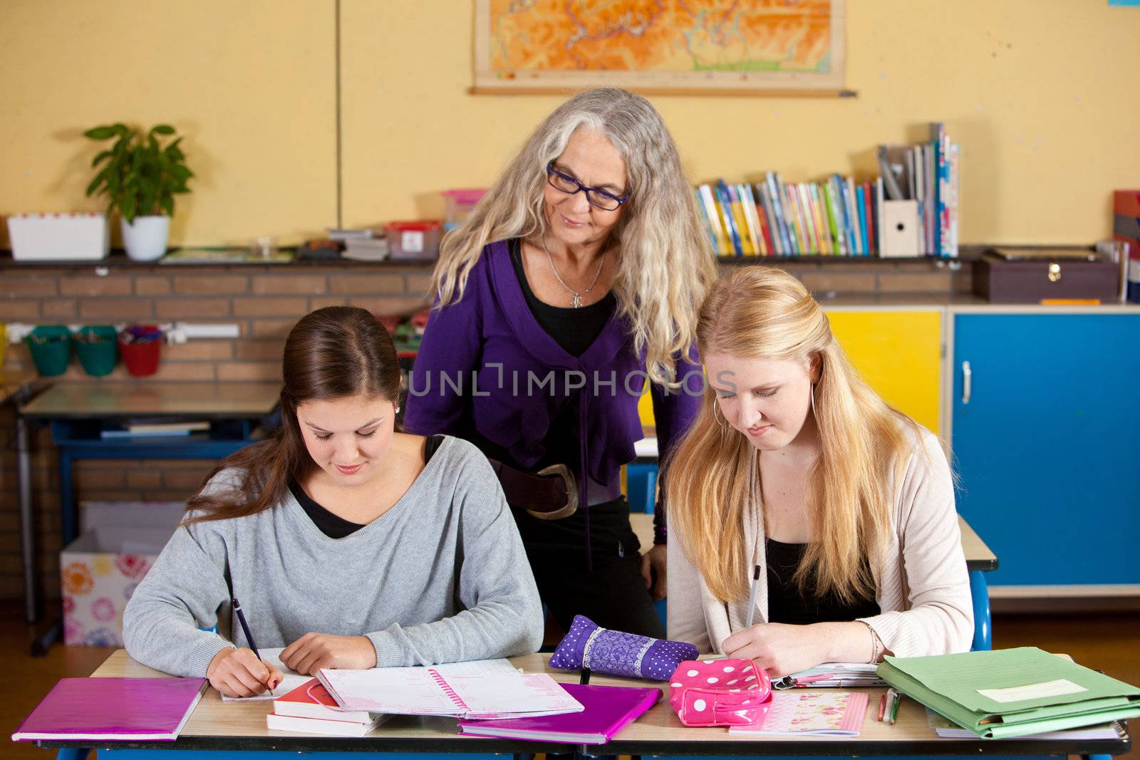 Teacher checking on her students by Fotosmurf
