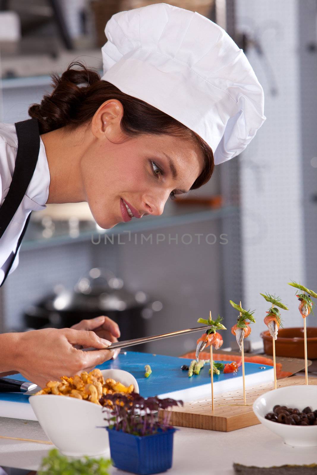 Female chef putting the finishing touch to a small amuse