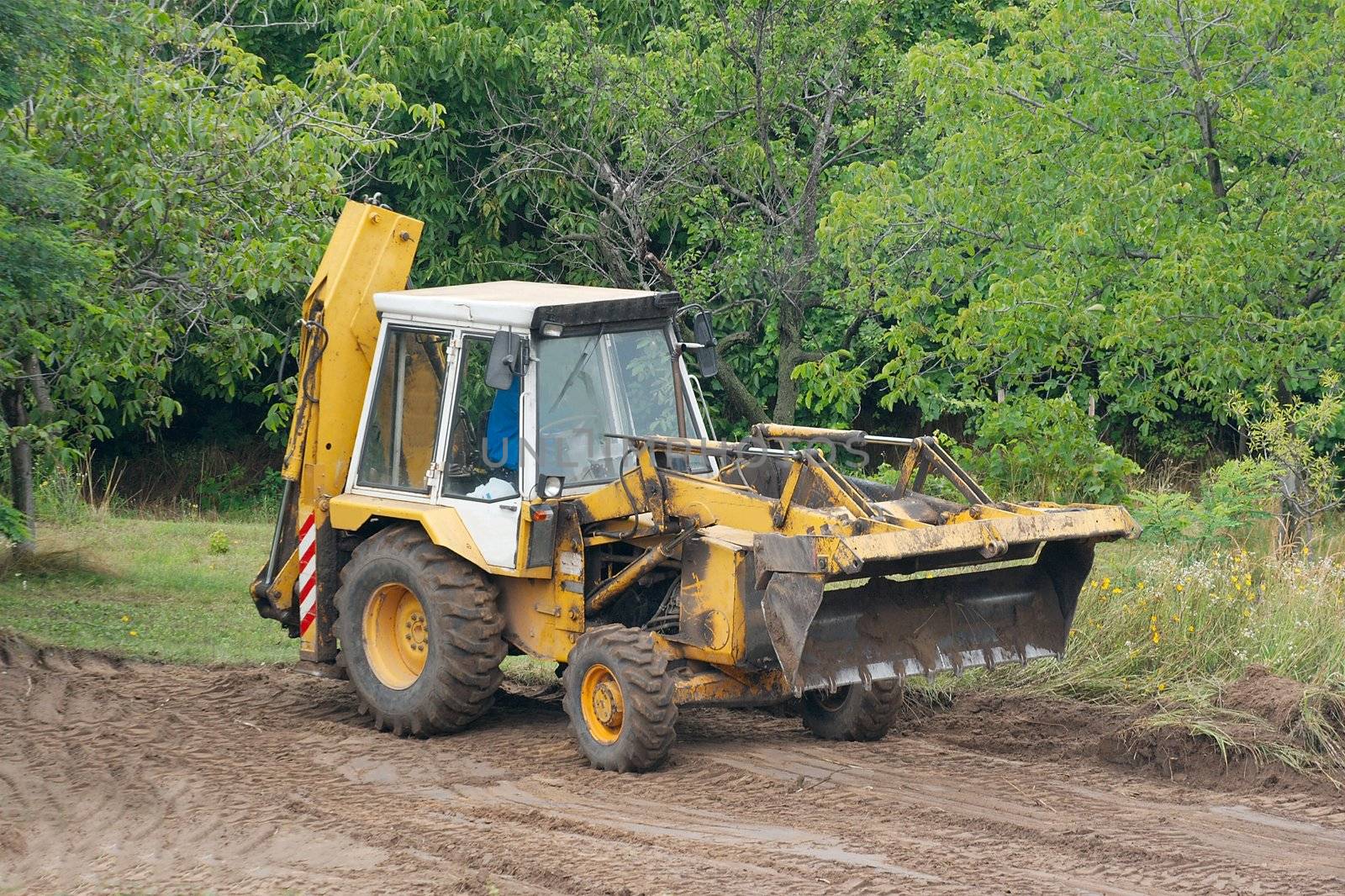 Excavator working on the field