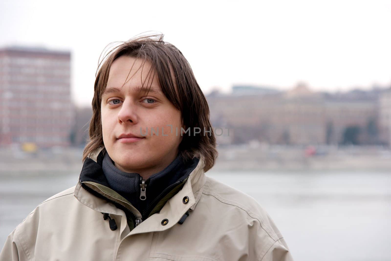 Young student boy portrait in a foggy city