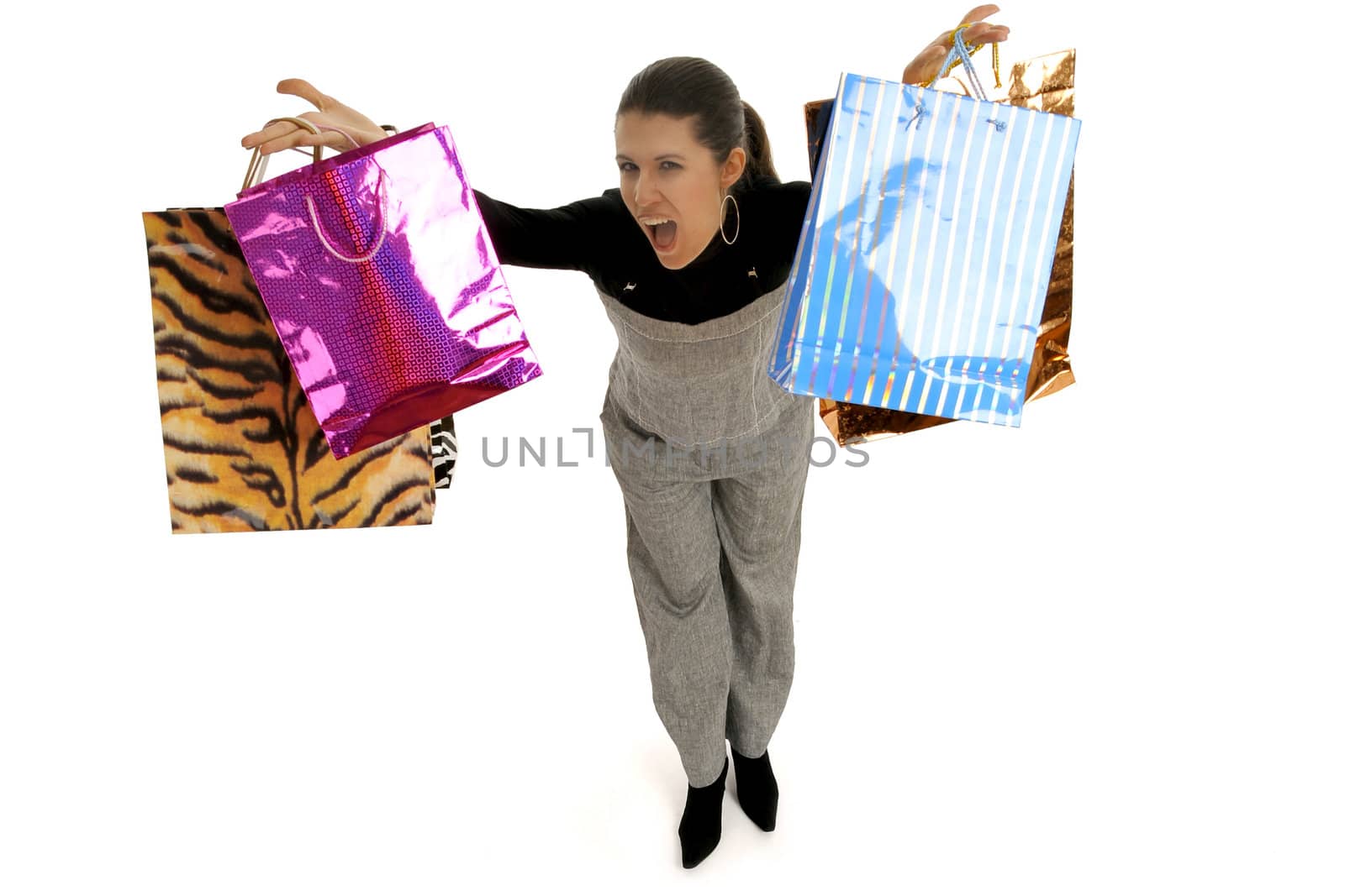 Full body view of young attractive woman in business wear,  going shopping with lots of colorful shopping bags. Isolated on white background.