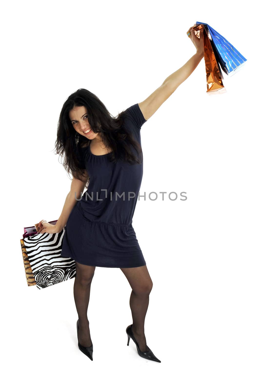 Full body view of young attractive woman in elegant wear,  going shopping with lots of colorful shopping bags. Isolated on white background.