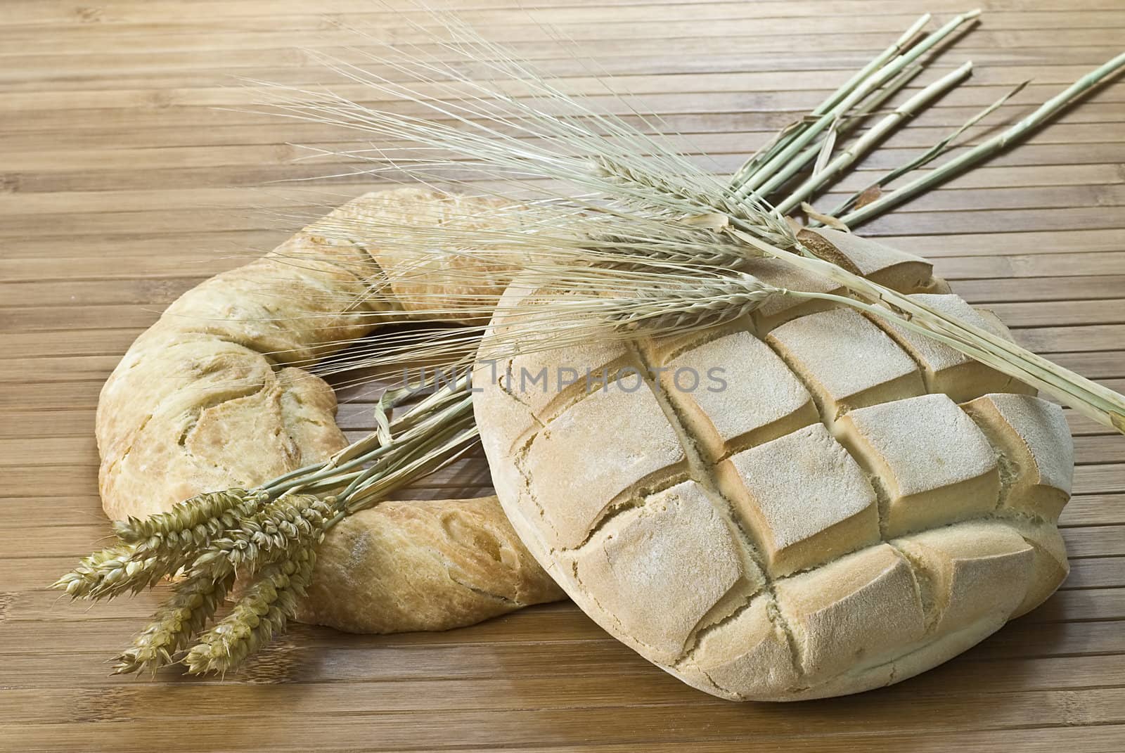 Some types of bread on a bamboo background.