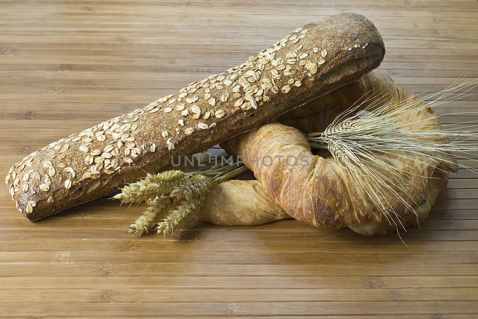 Some types of bread on a bamboo background.