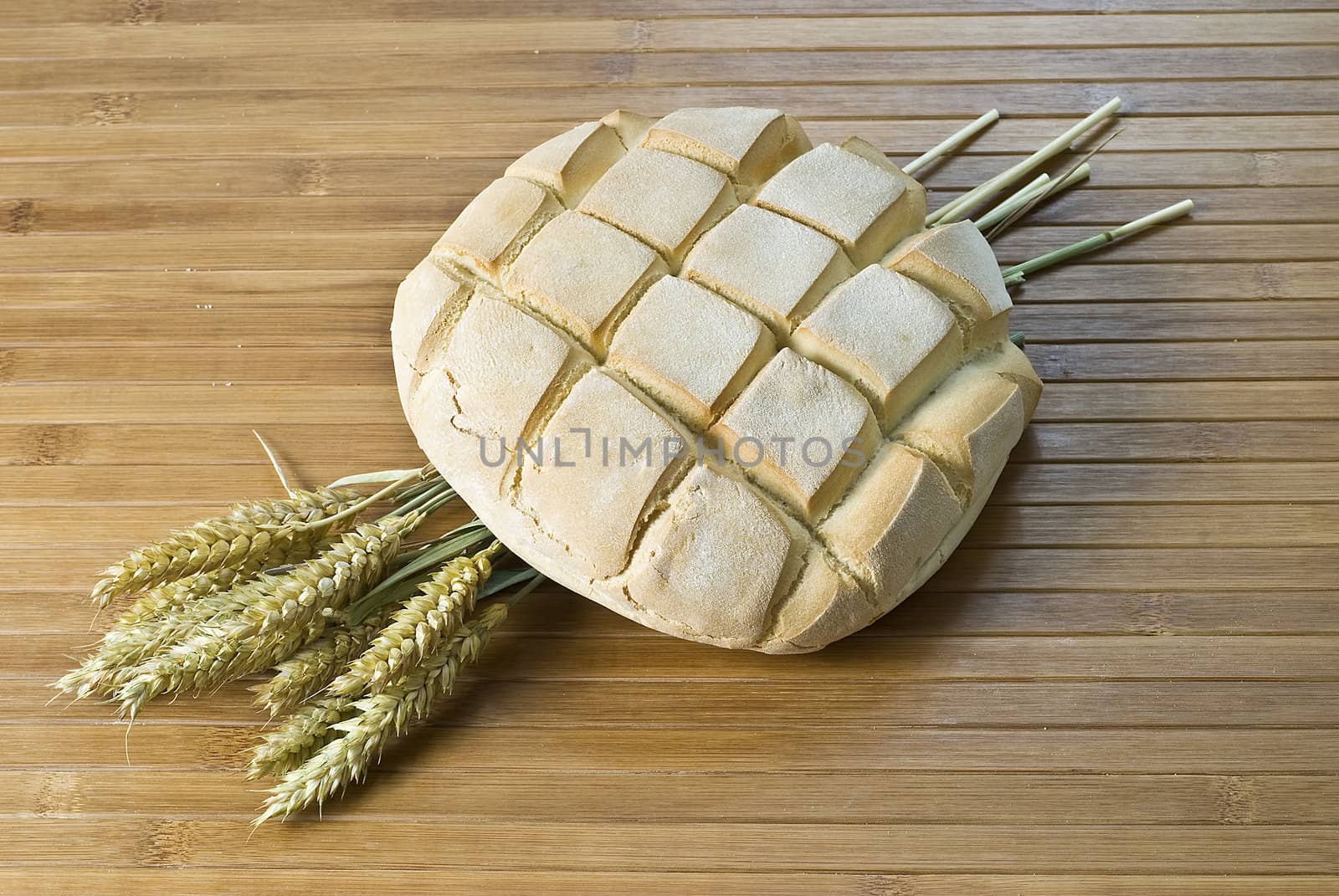 Some types of bread on a bamboo background.