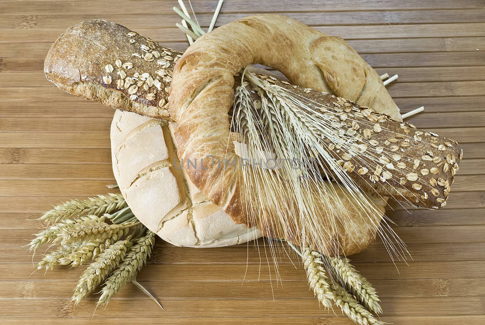 Some types of bread on a bamboo background.