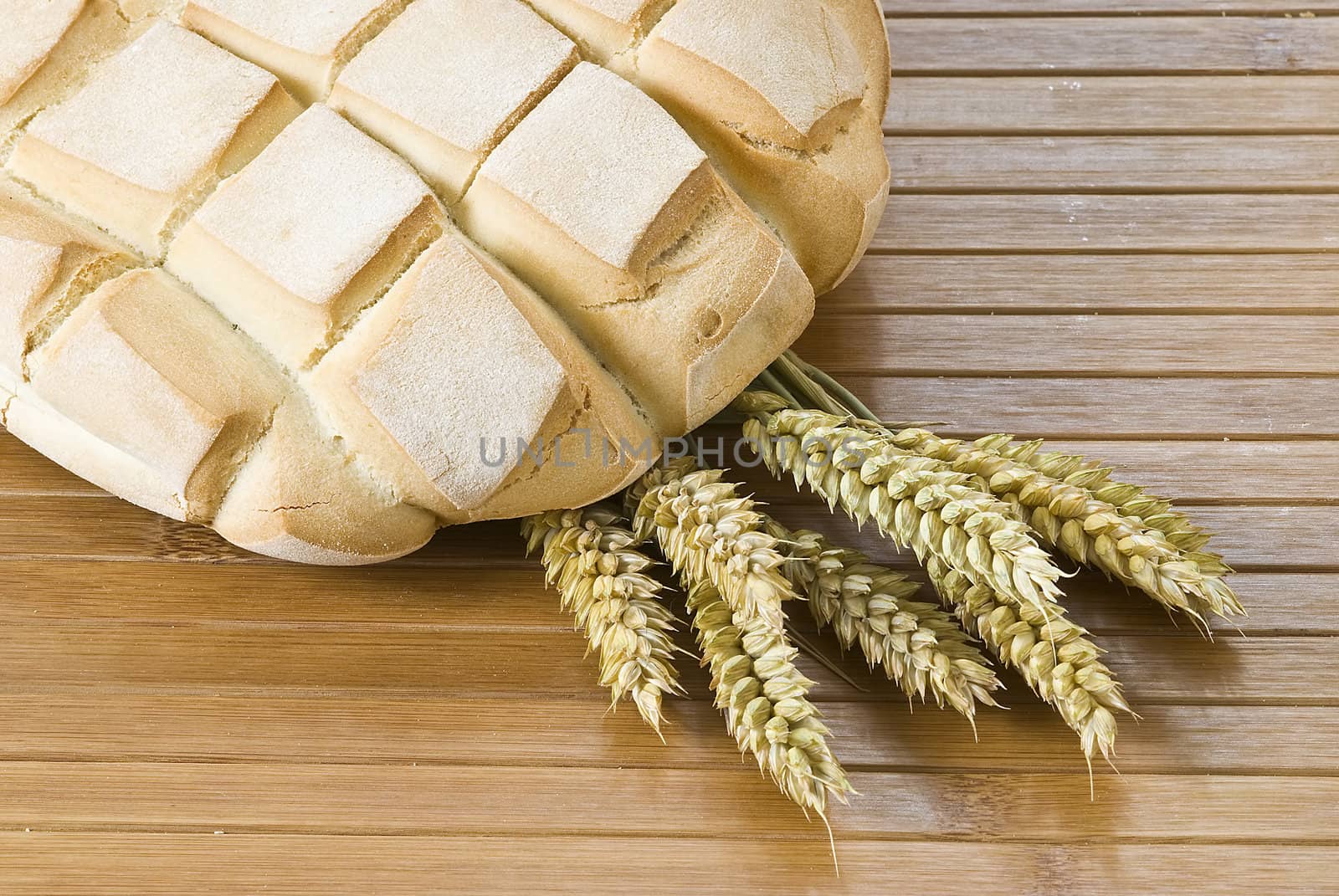 Some types of bread on a bamboo background.