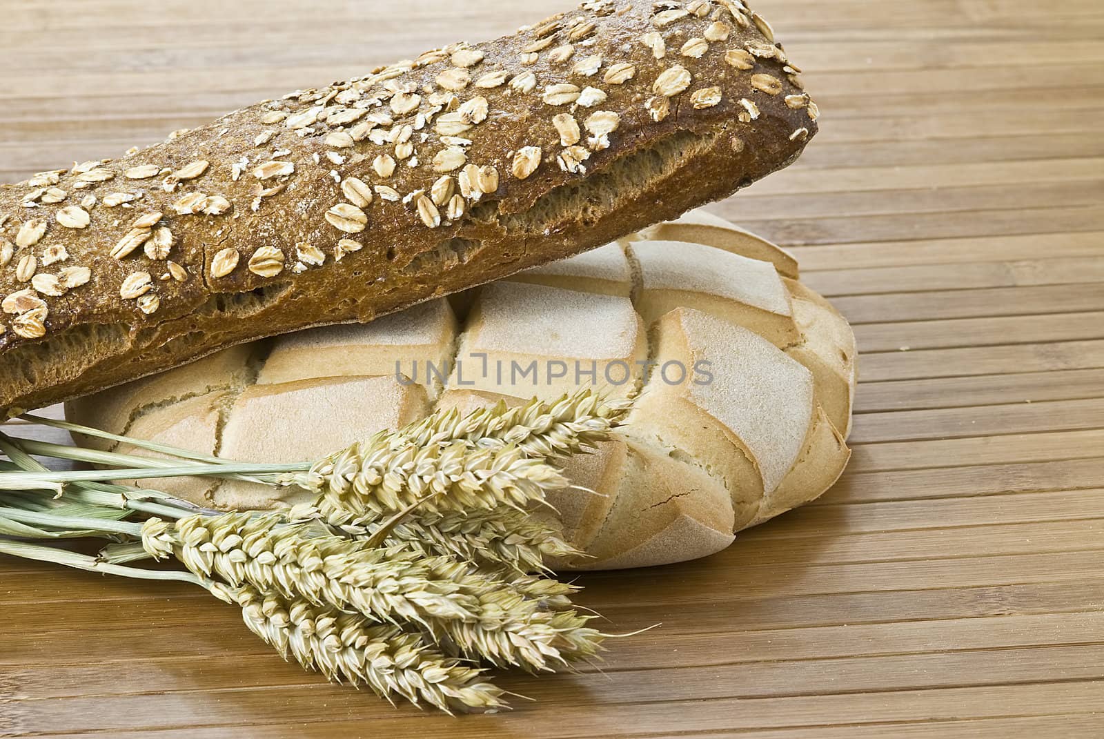 Some types of bread on a bamboo background.