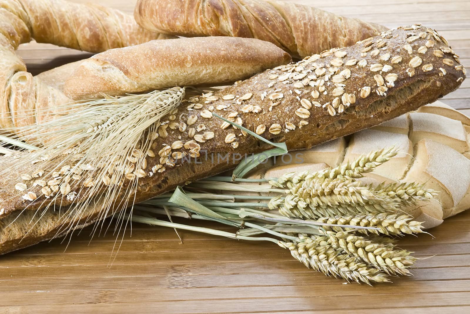 Some types of bread on a bamboo background.