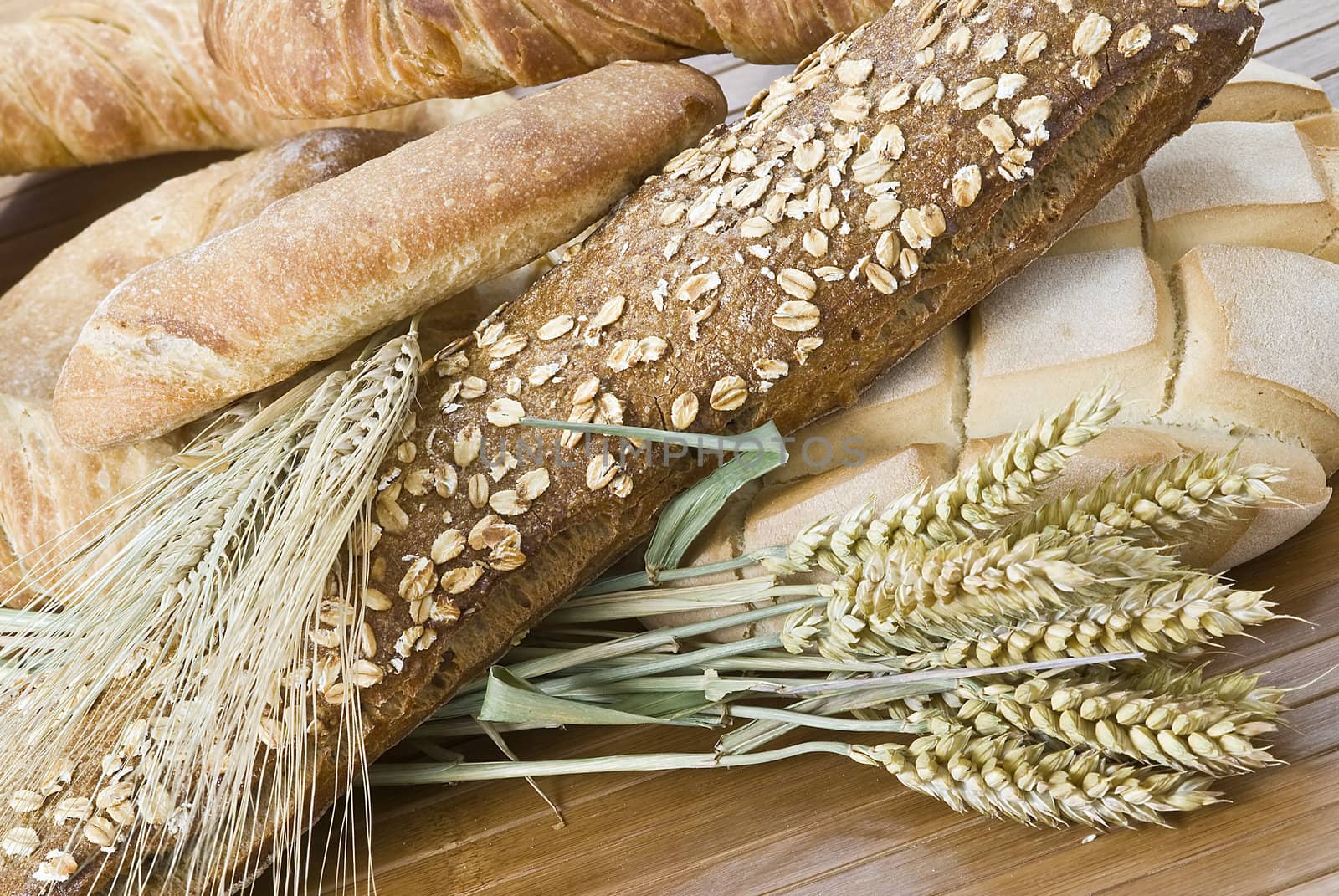 Some types of bread on a bamboo background.