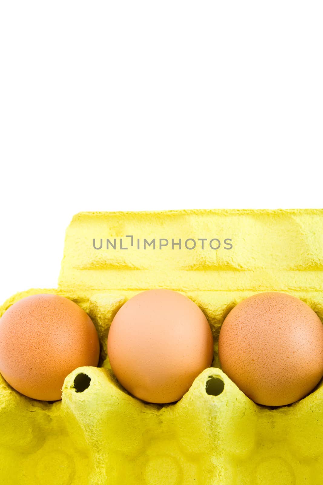 Carton of few eggs in a cardboard box. Isolated on white background.