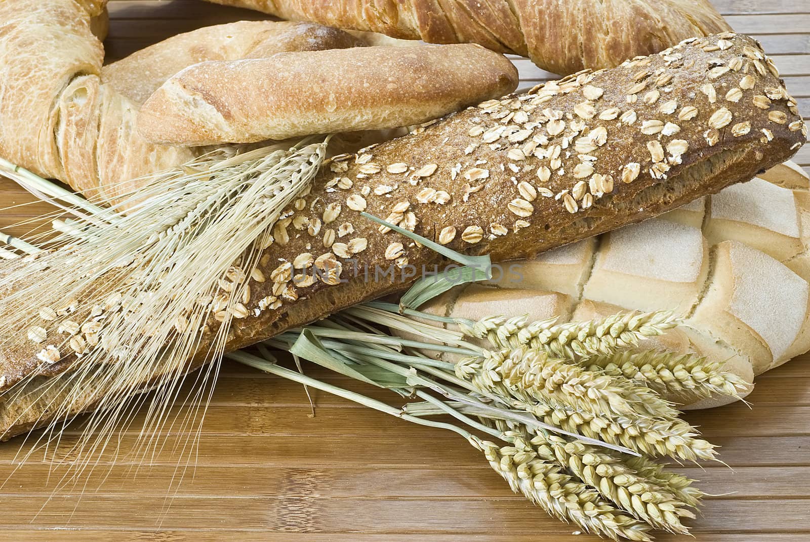 Some types of bread on a bamboo background.