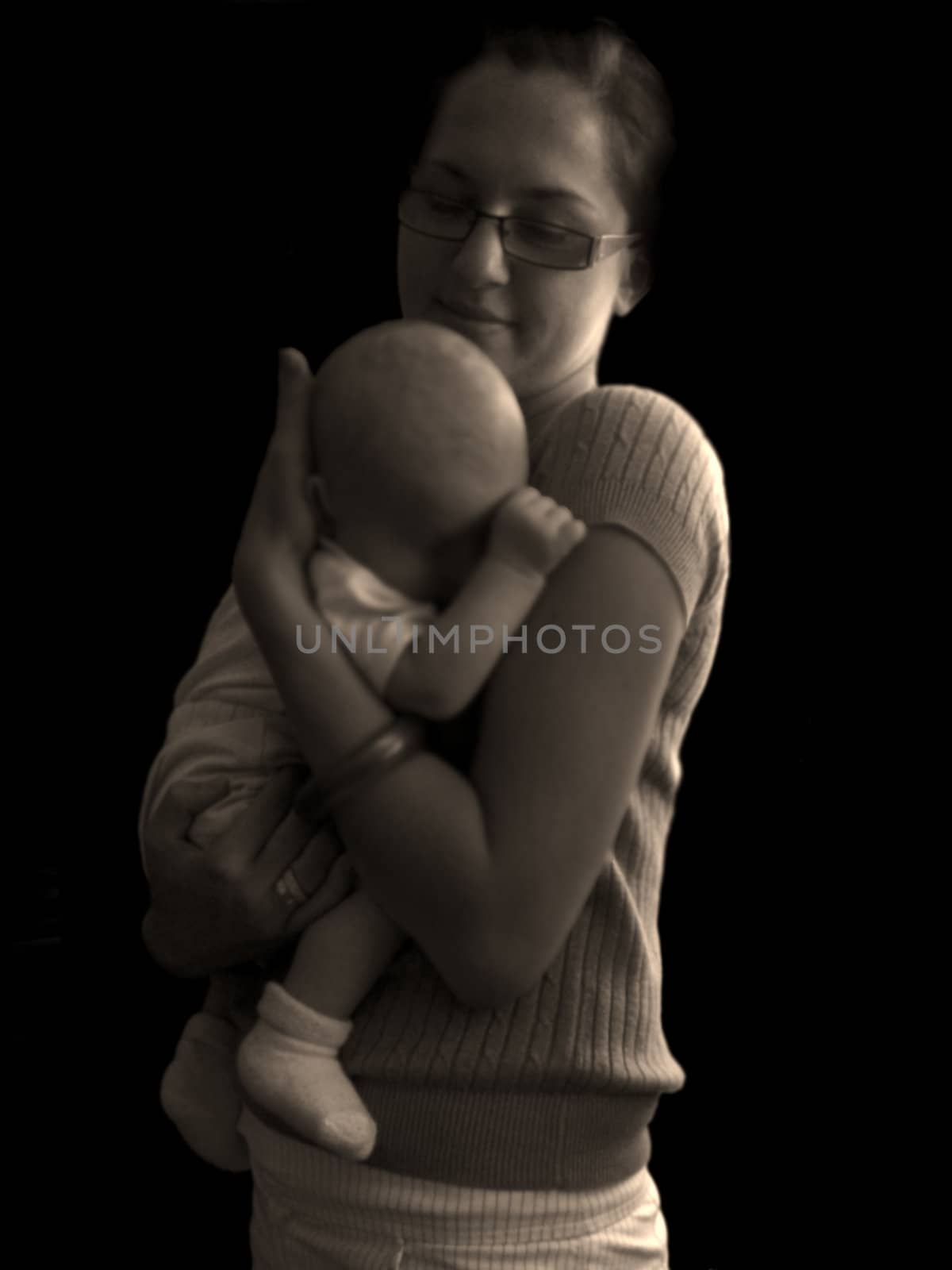 A small baby in young mother's arms