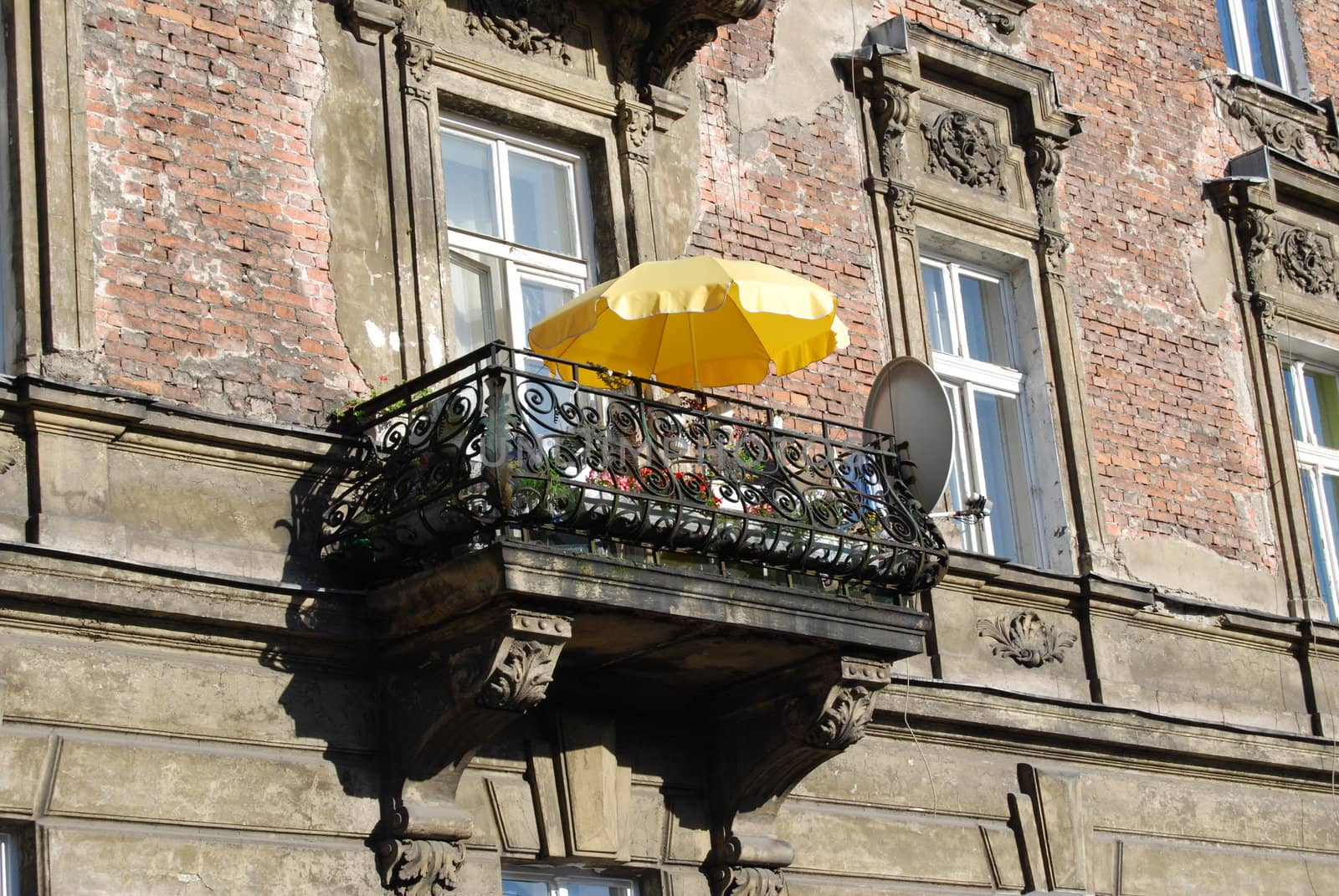 a window with yellow umbrella in krakow, poland, europe