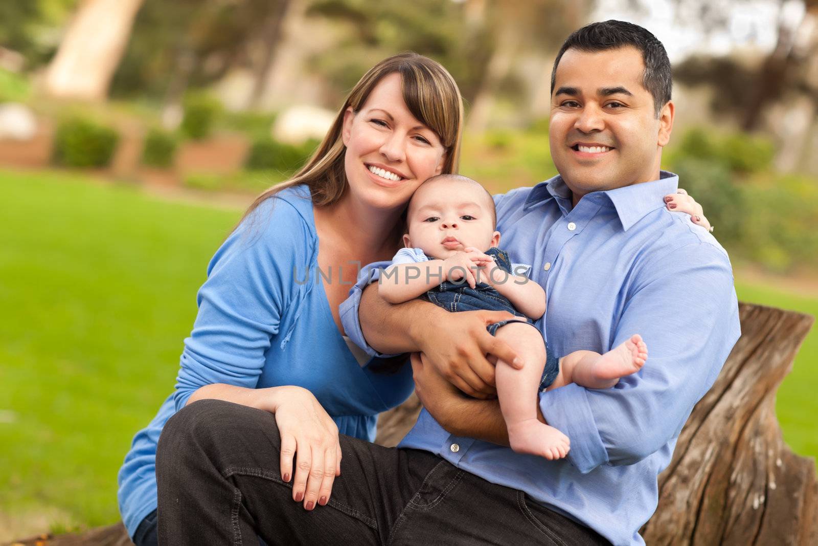 Happy Mixed Race Family Posing for A Portrait in the Park.