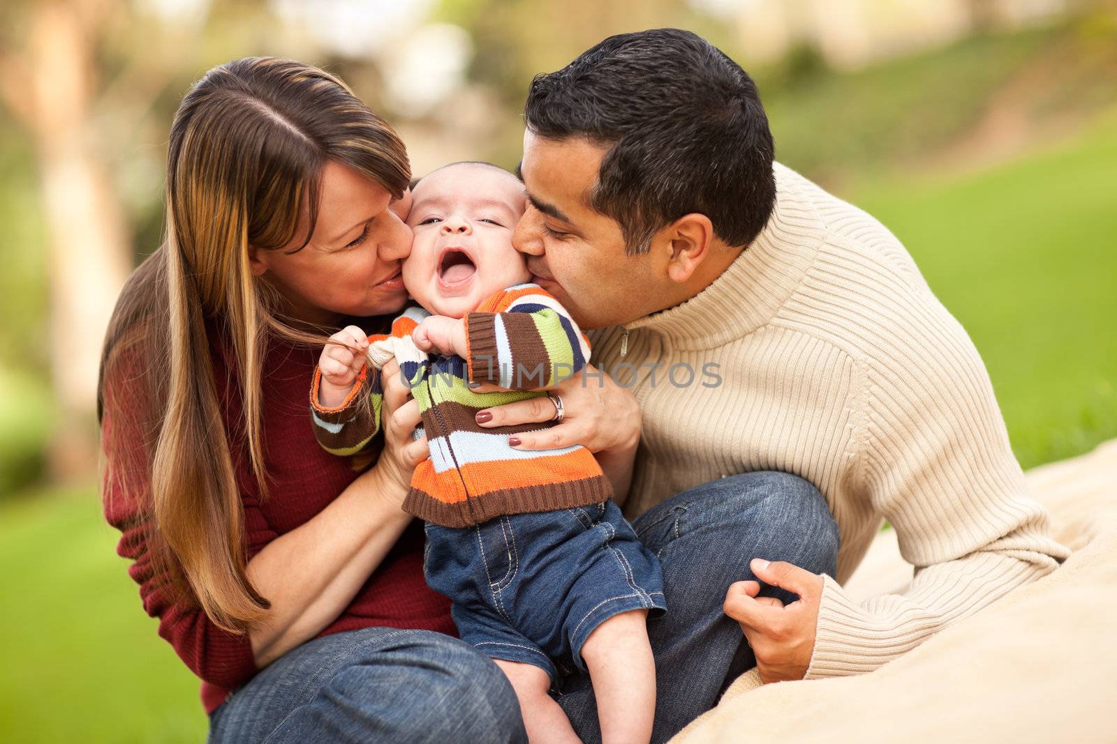 Happy Mixed Race Parents Playing with Their Giggling Son.