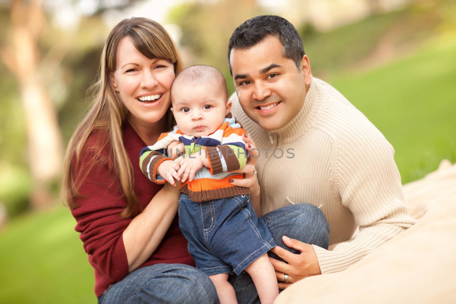 Happy Mixed Race Family Posing for A Portrait in the Park.