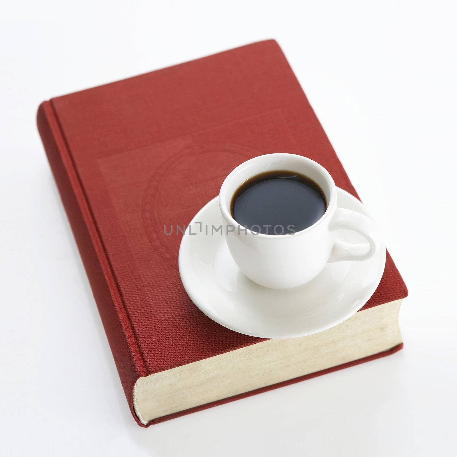 A cup of coffee on the book