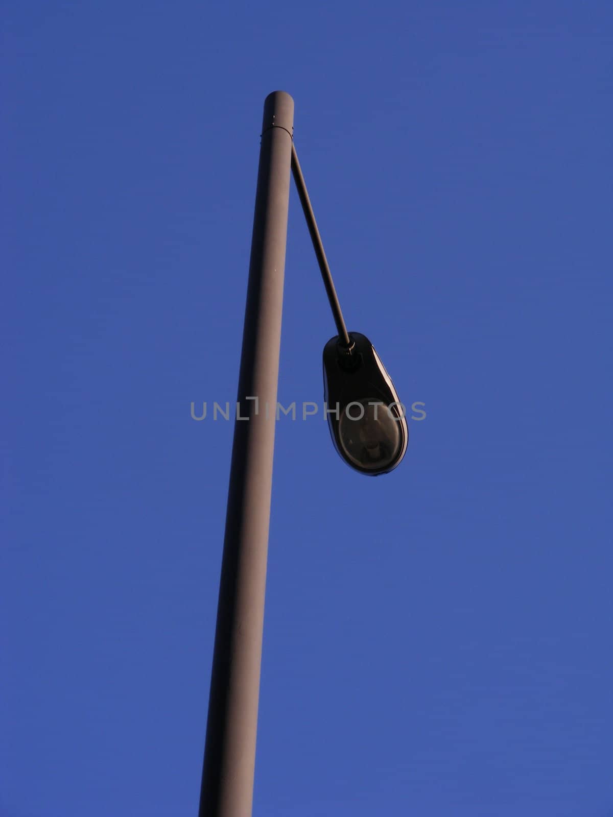 A photograph of a lamppost midday.