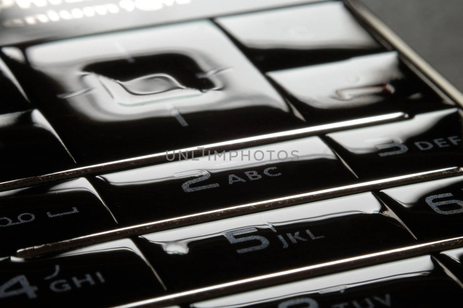 Close up shot of blue mobile keypad under dark environment